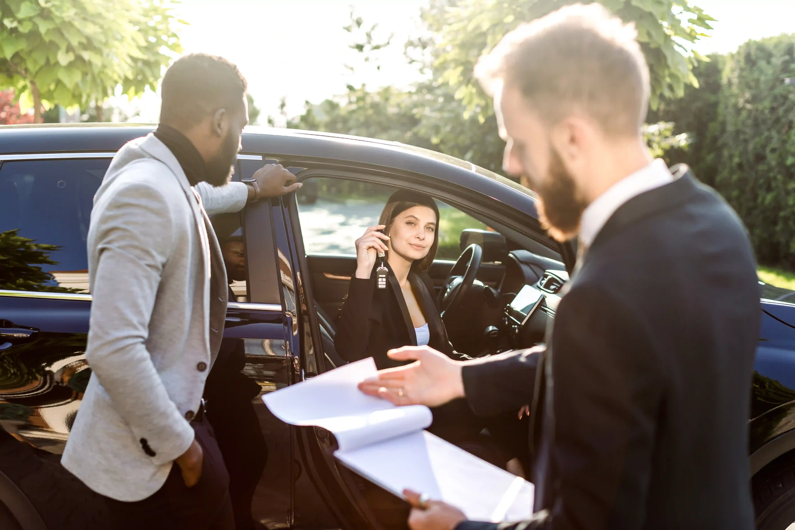 A businesswoman receiving car keys as part of a contract transport auto service.