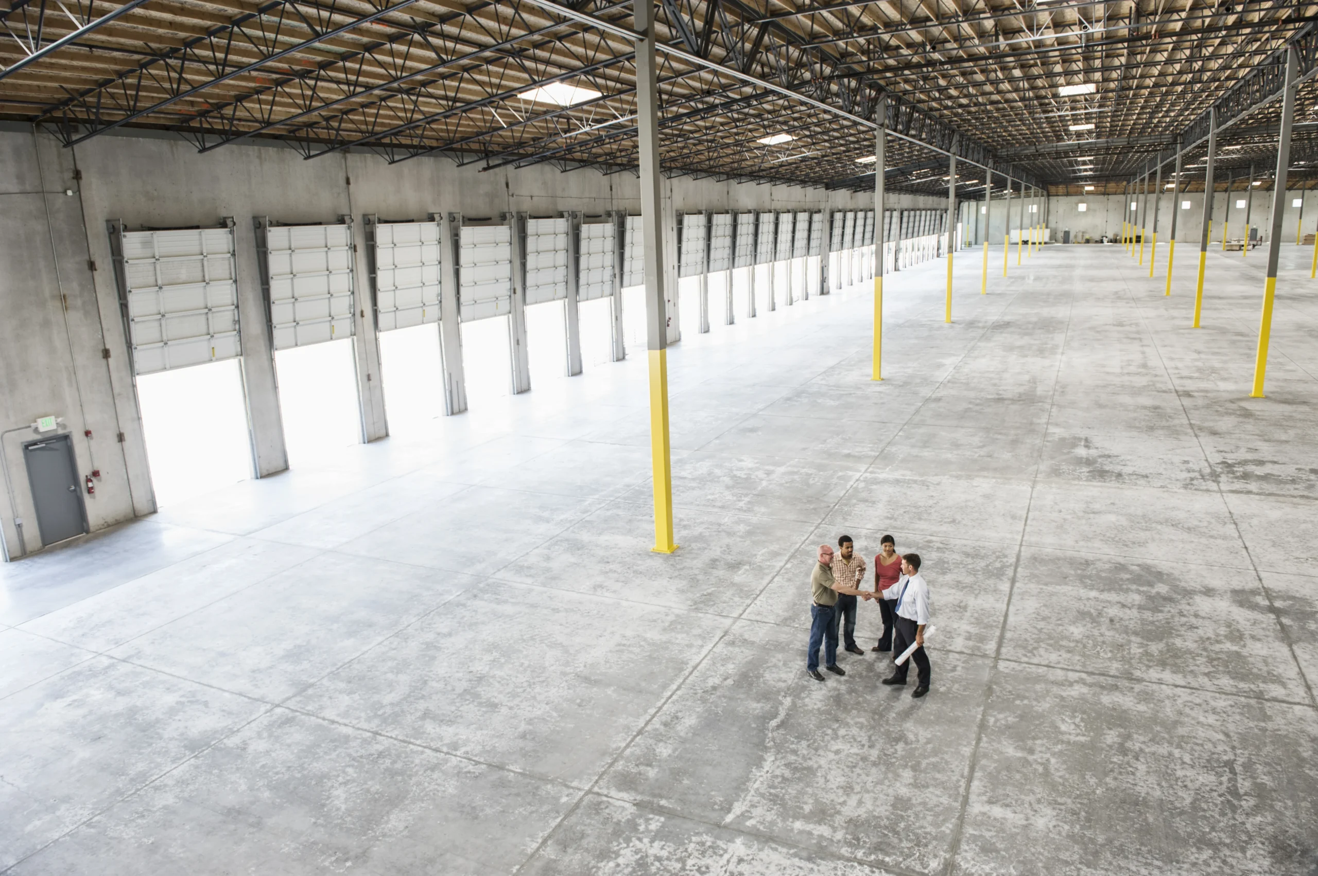 Team inspecting the interior of a new warehouse space at a cross dock center.