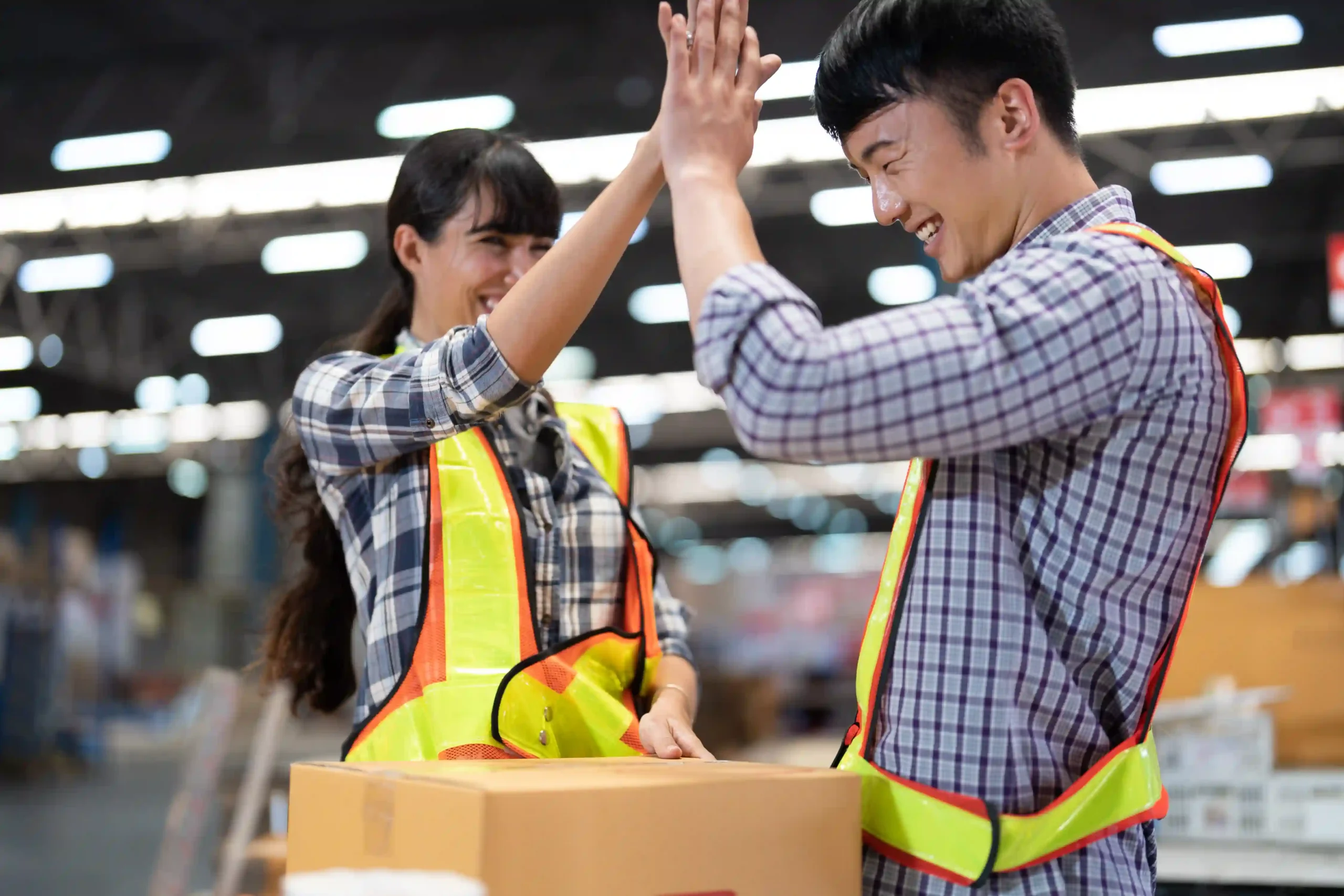 Warehouse staff celebrating successful and timely order delivery services