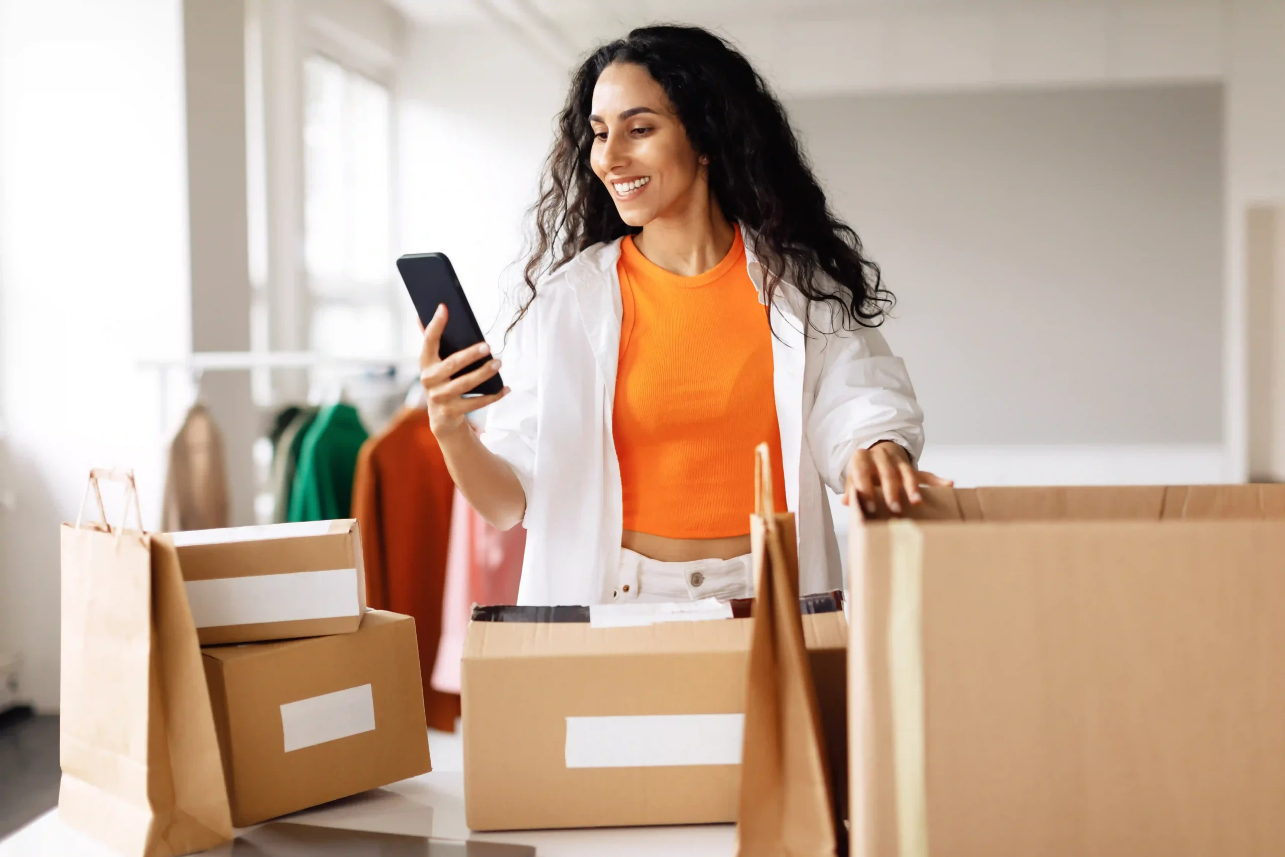 Woman using an order fulfillment app to manage online store shipments from home