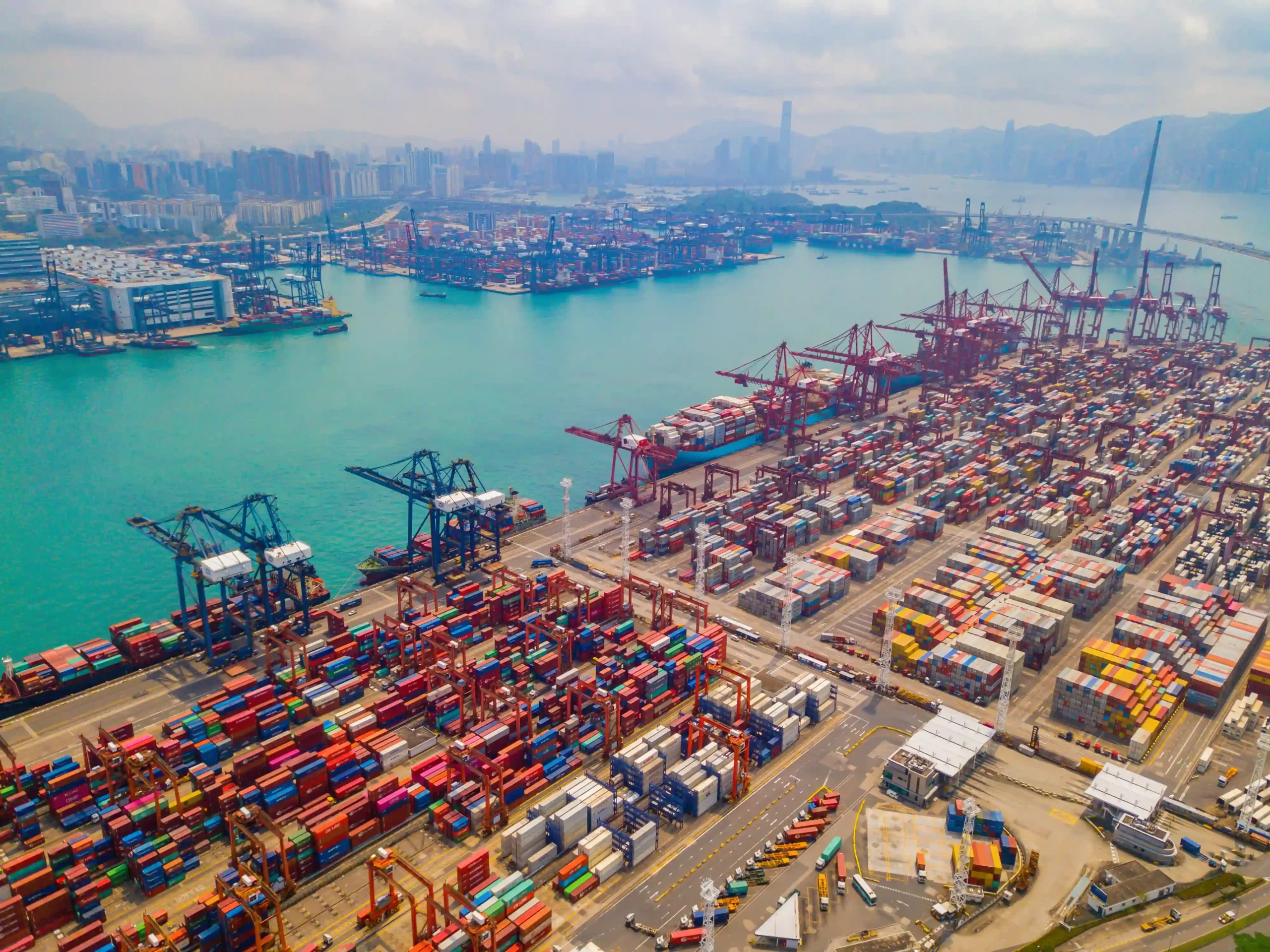 Aerial view of global shipping port illustrating international trade logistics under trade compliance regulations 2025.