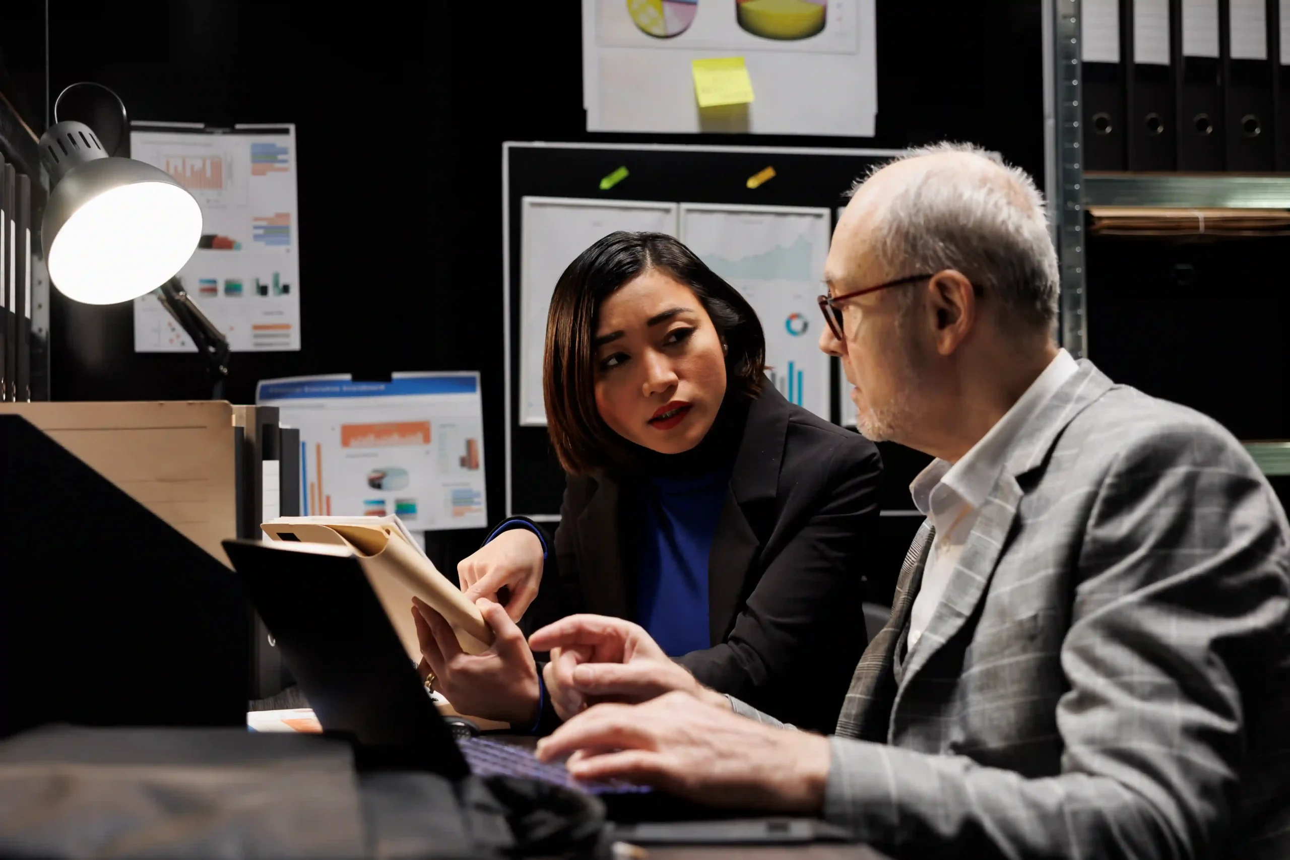 Business analysts evaluating performance metrics for outsourced inventory management