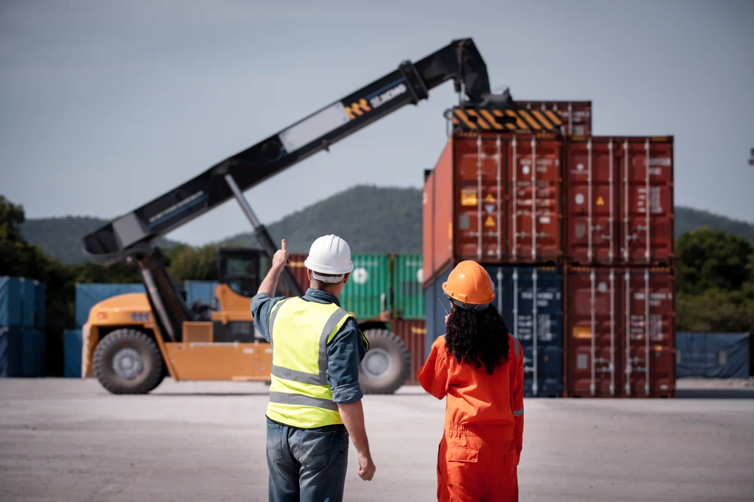 Team of 3PL logistics workers coordinating container freight for a small business supply chain operation