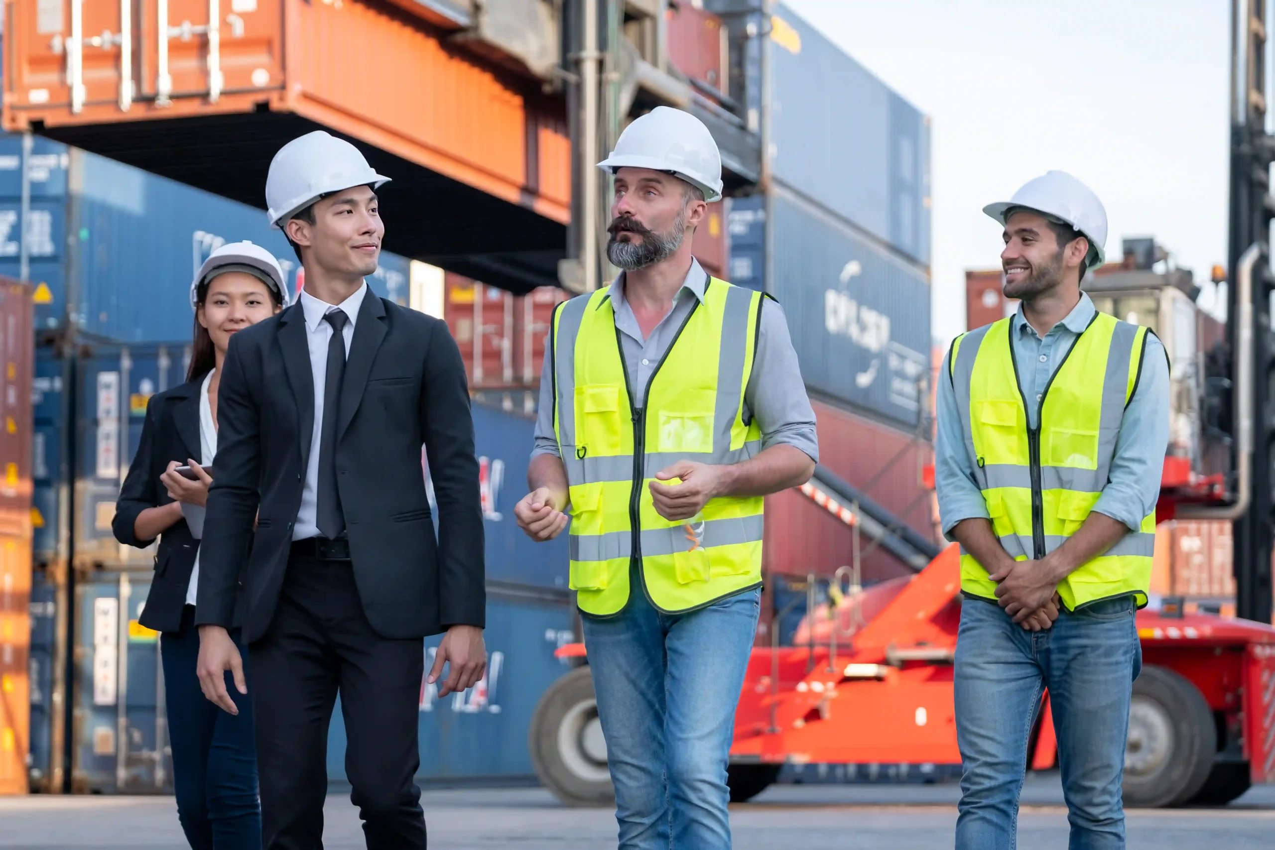 Team of 3PL logistics process managers walking through international freight terminal