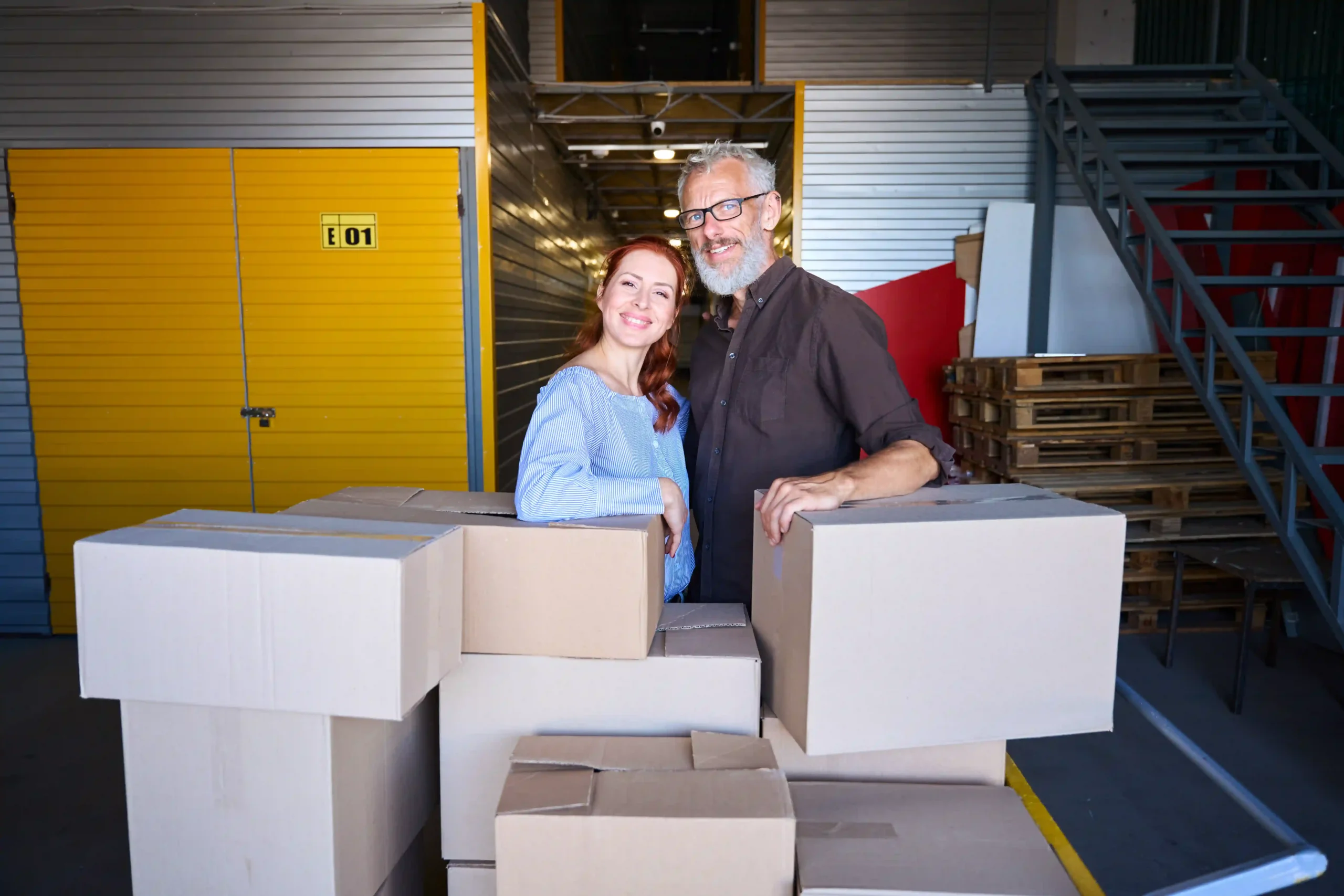 Business owners assessing 3PL pallet storage cost after warehouse delivery at a fulfillment facility.