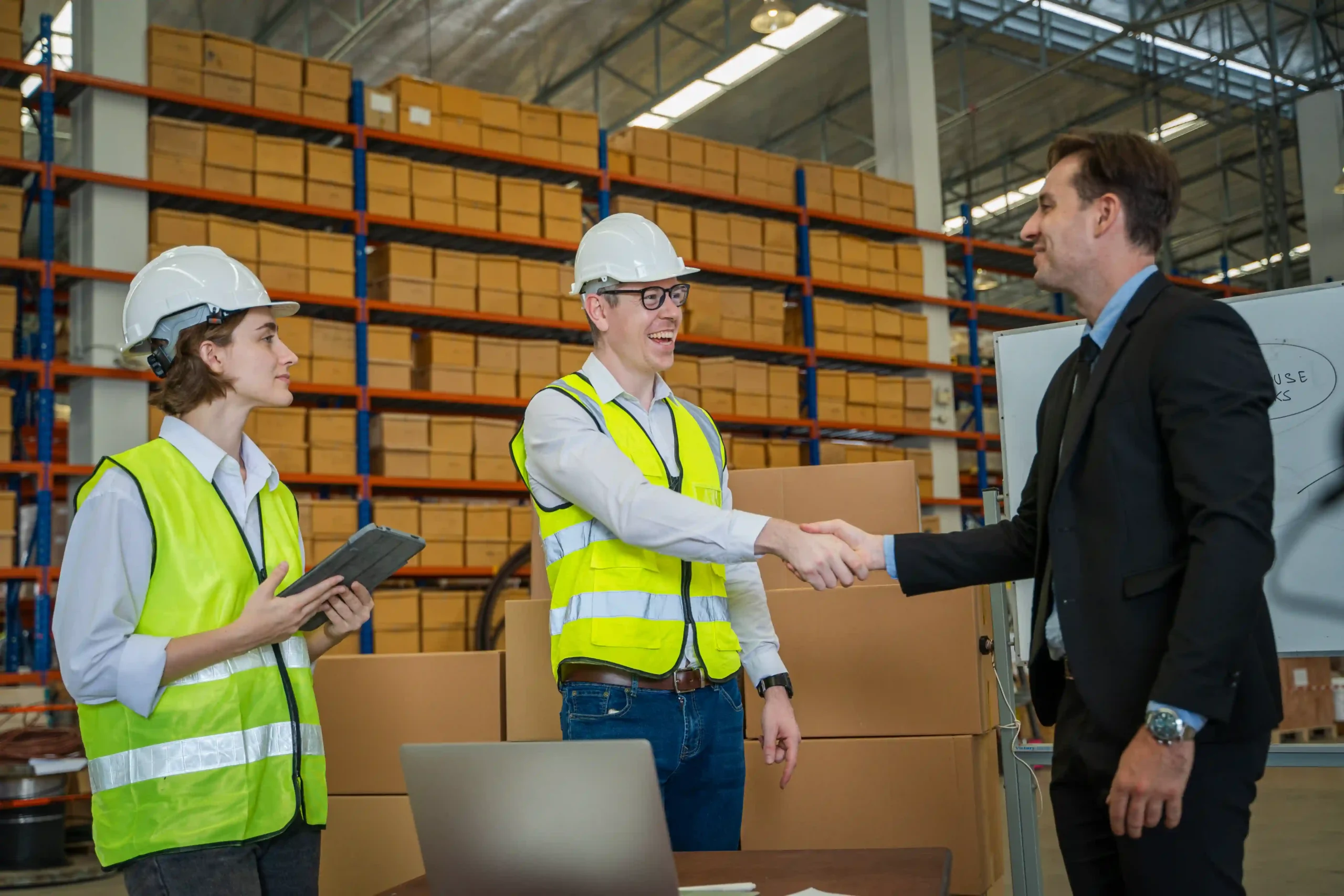 Business leaders and warehouse staff collaborating on a fulfillment strategy — distribution logistics meaning in modern operations