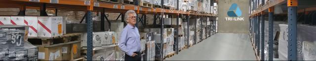 Man standing in warehouse in front of packing shelves