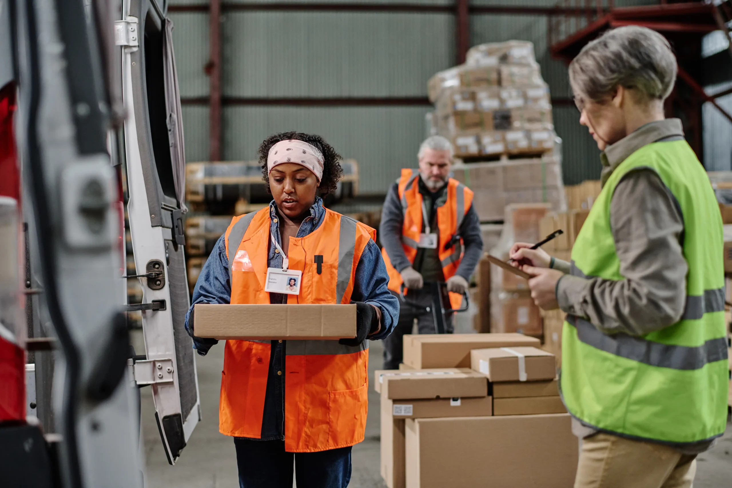 Warehouse workers loading and managing cargo packages for delivery, showcasing efficient freight operations