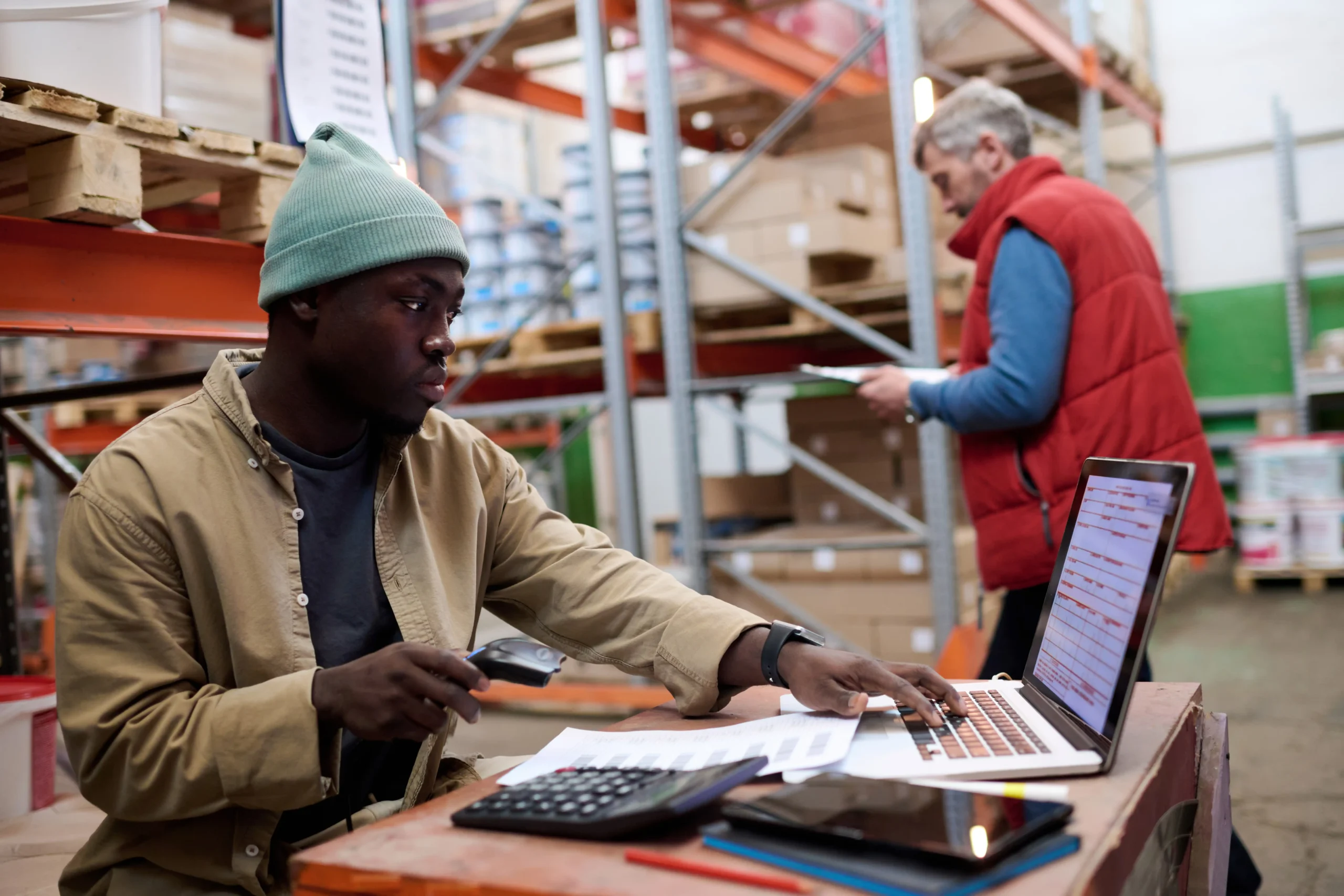 Warehouse worker scanning barcodes to track inventory in real-time.