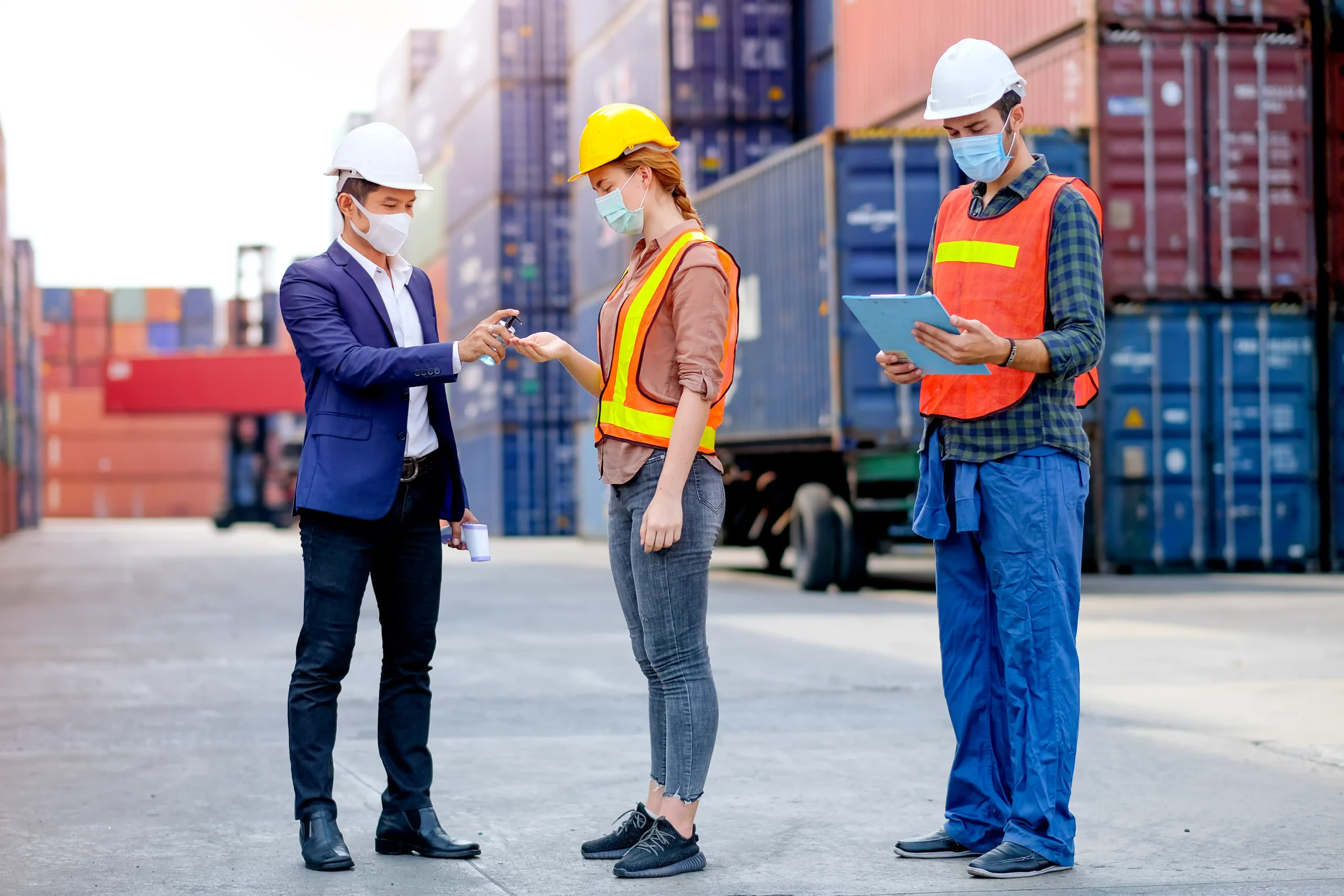 Compliance consulting expert providing guidance to logistics workers in a shipping yard to ensure safe and regulatory-compliant operations.