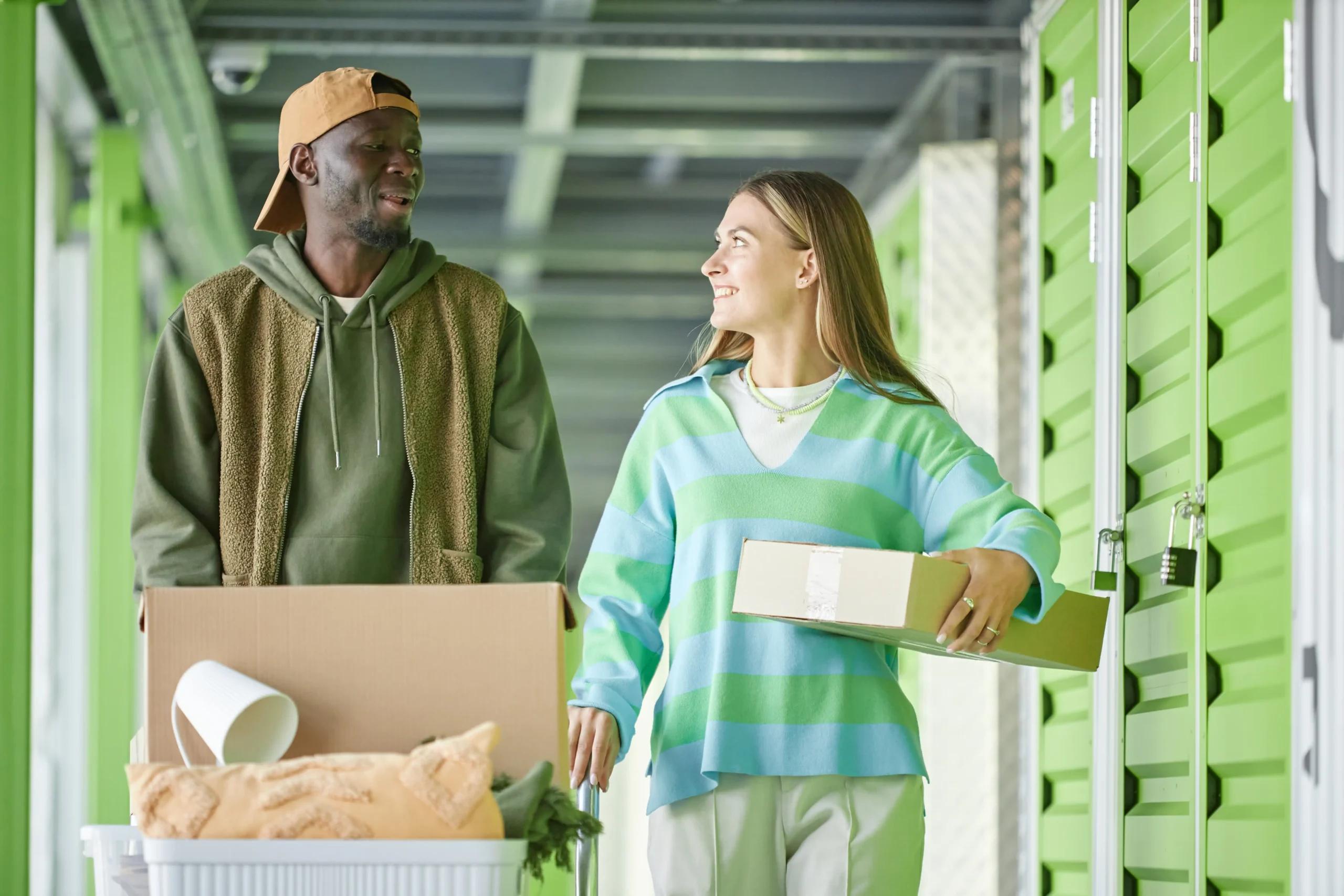 A couple transporting items in a green storage facility, reflecting eco-friendly warehousing practices.