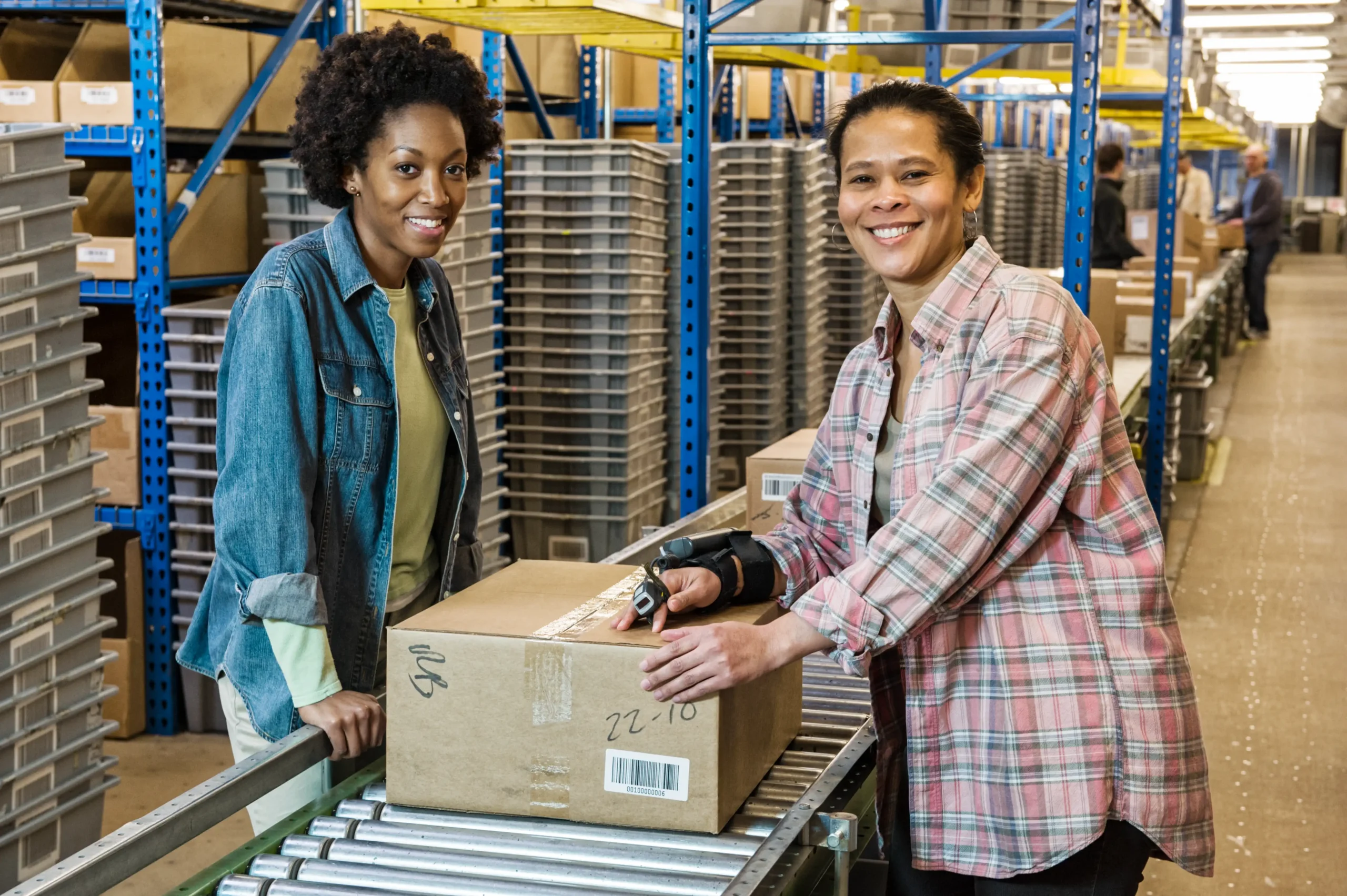 A multi-ethnic team of female warehouse workers managing supply chain logistics.