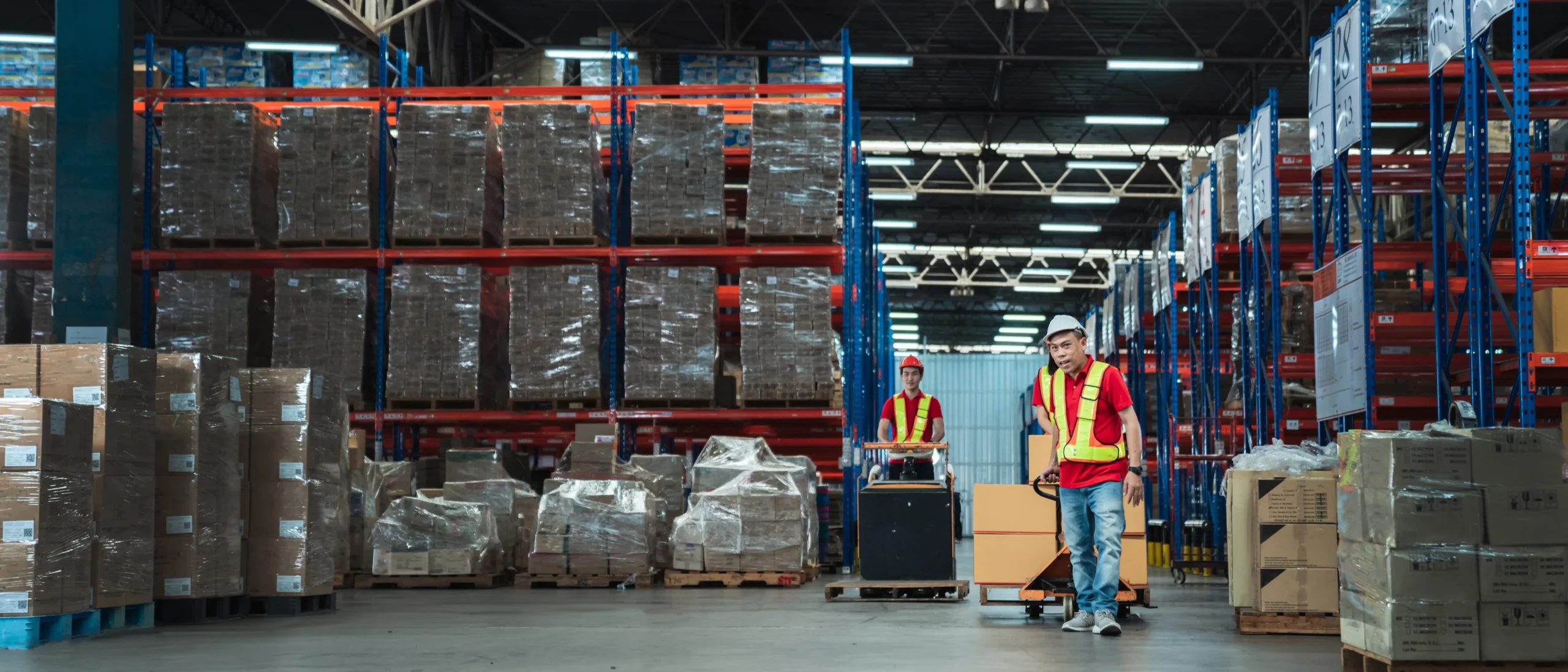 Warehouse workers inspecting inventory stock in a free trade zone facility, demonstrating efficient stock management