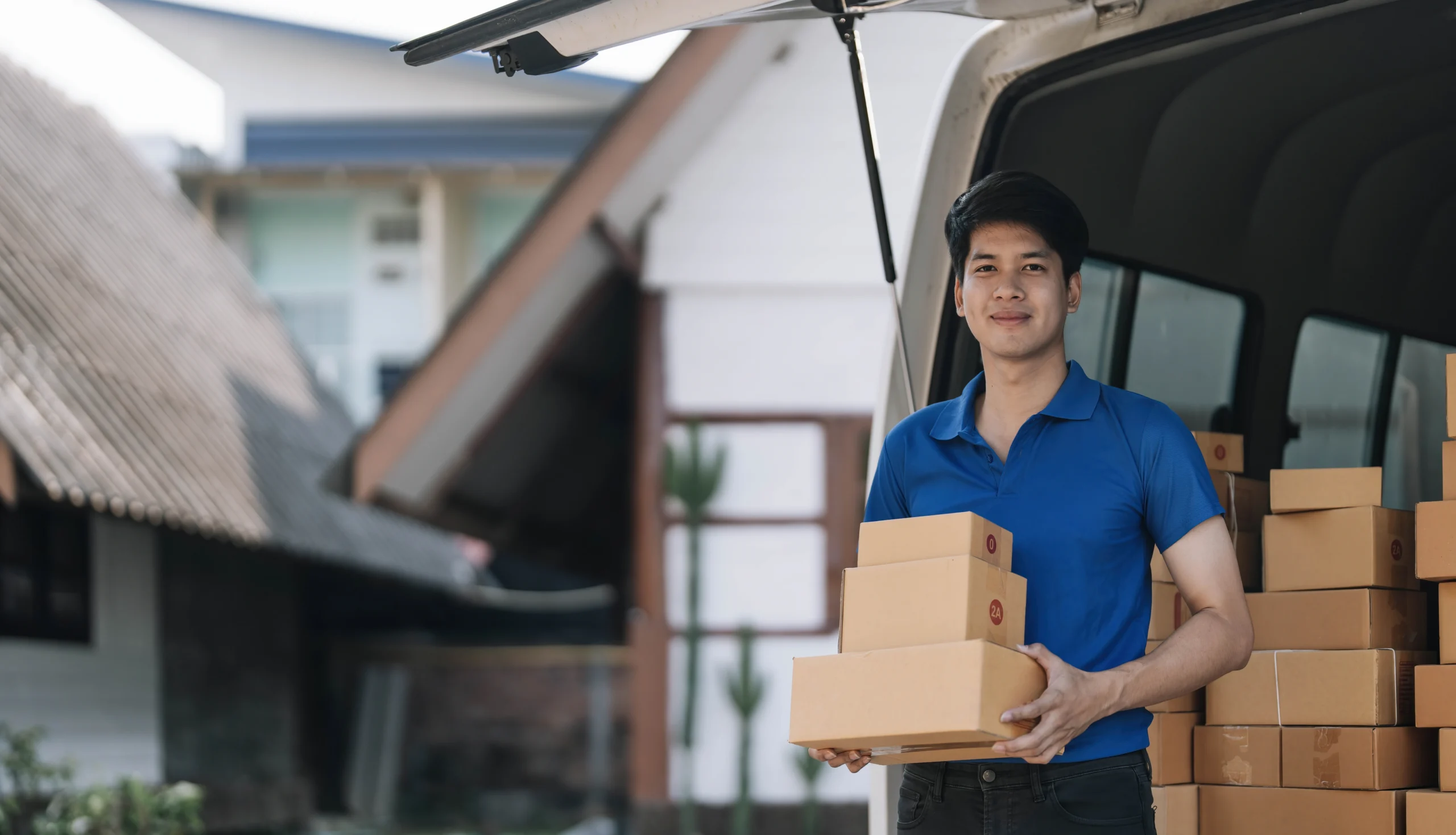 Asian courier delivering packages, representing the efficiency and customer satisfaction enabled by 3PL value-added services in logistics.