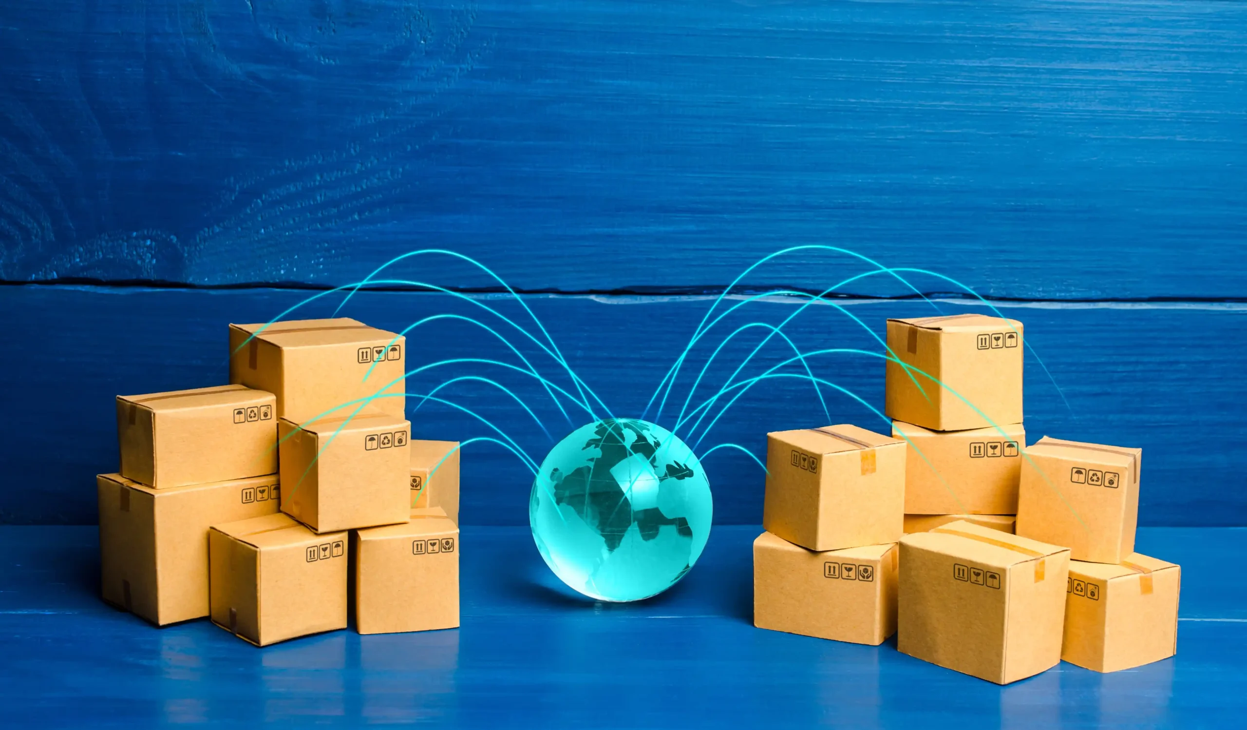 Cardboard boxes connected with a glowing globe concept, representing global delivery and supply chain logistics on a blue background.