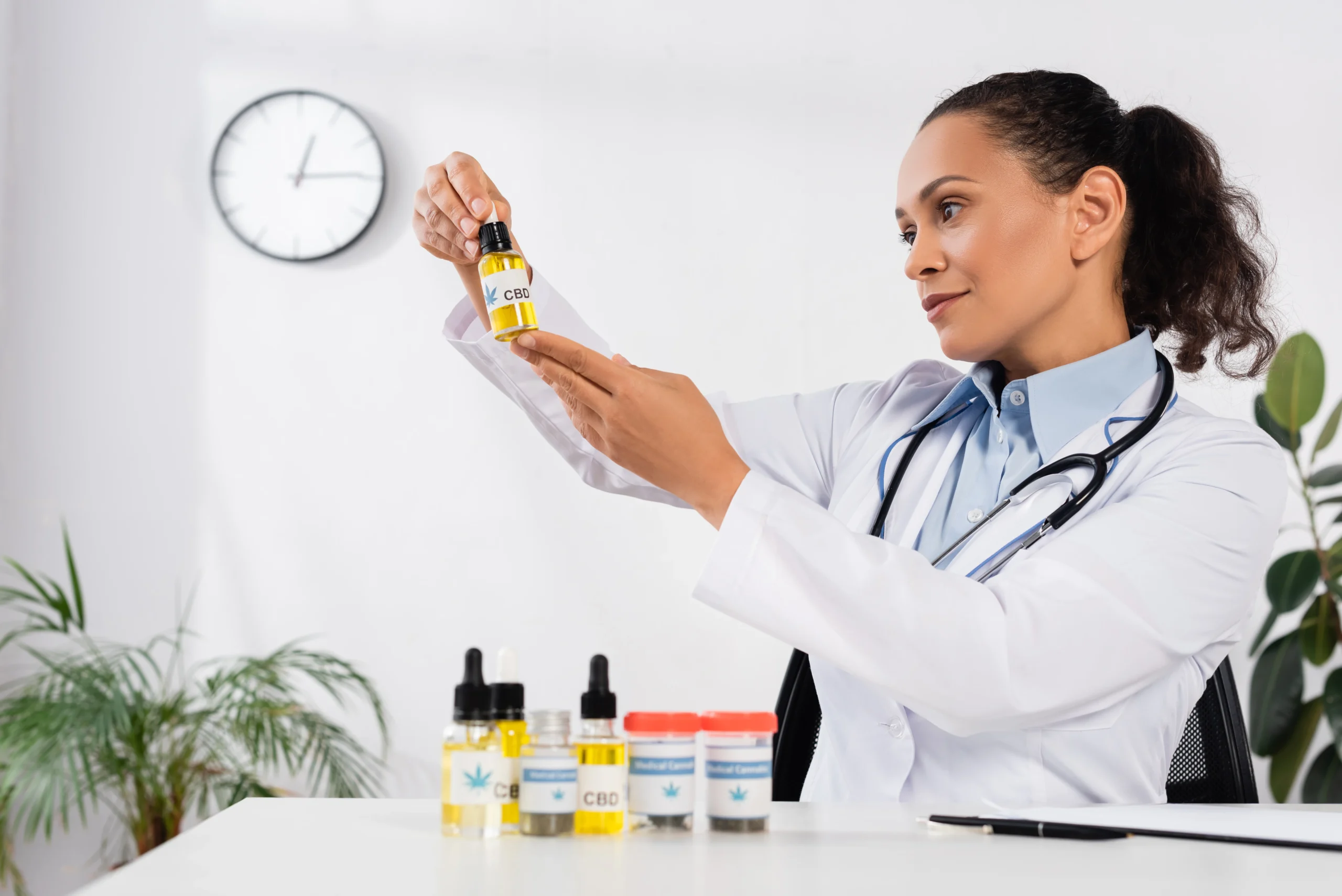 Brunette doctor inspecting a CBD product label for FDA compliance.