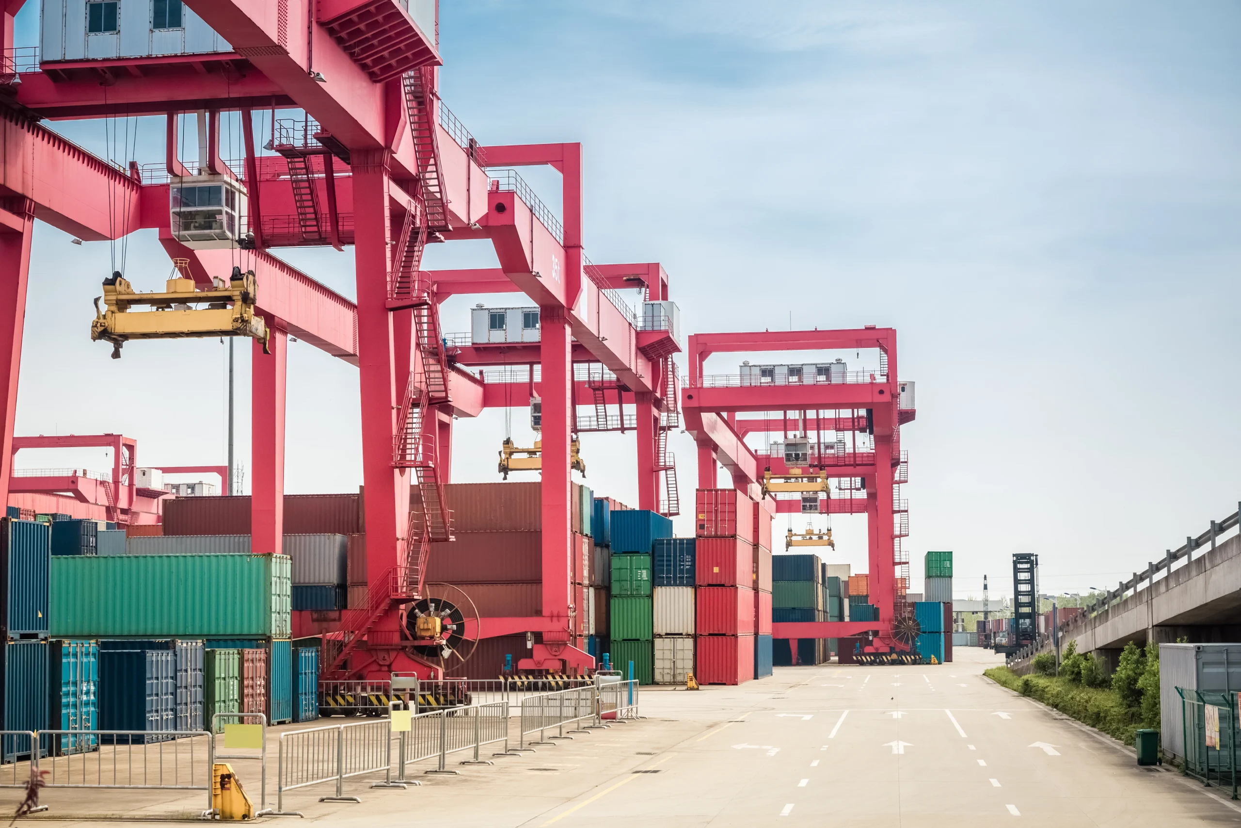 Container freight yard in an FTZ (Foreign Trade Zone), showcasing efficient global logistics operations with colorful cargo containers and cranes.