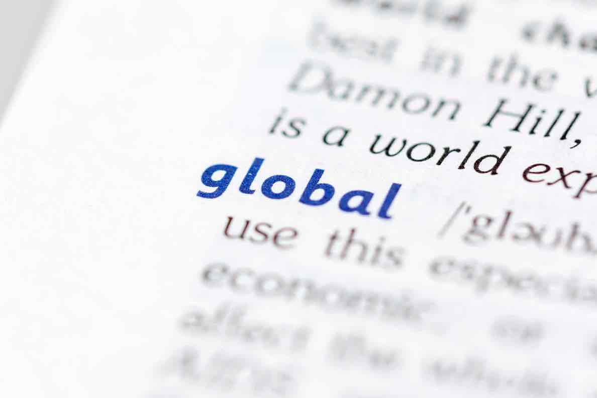 Close-up of the word 'global' highlighted in a dictionary, symbolizing international trade compliance.