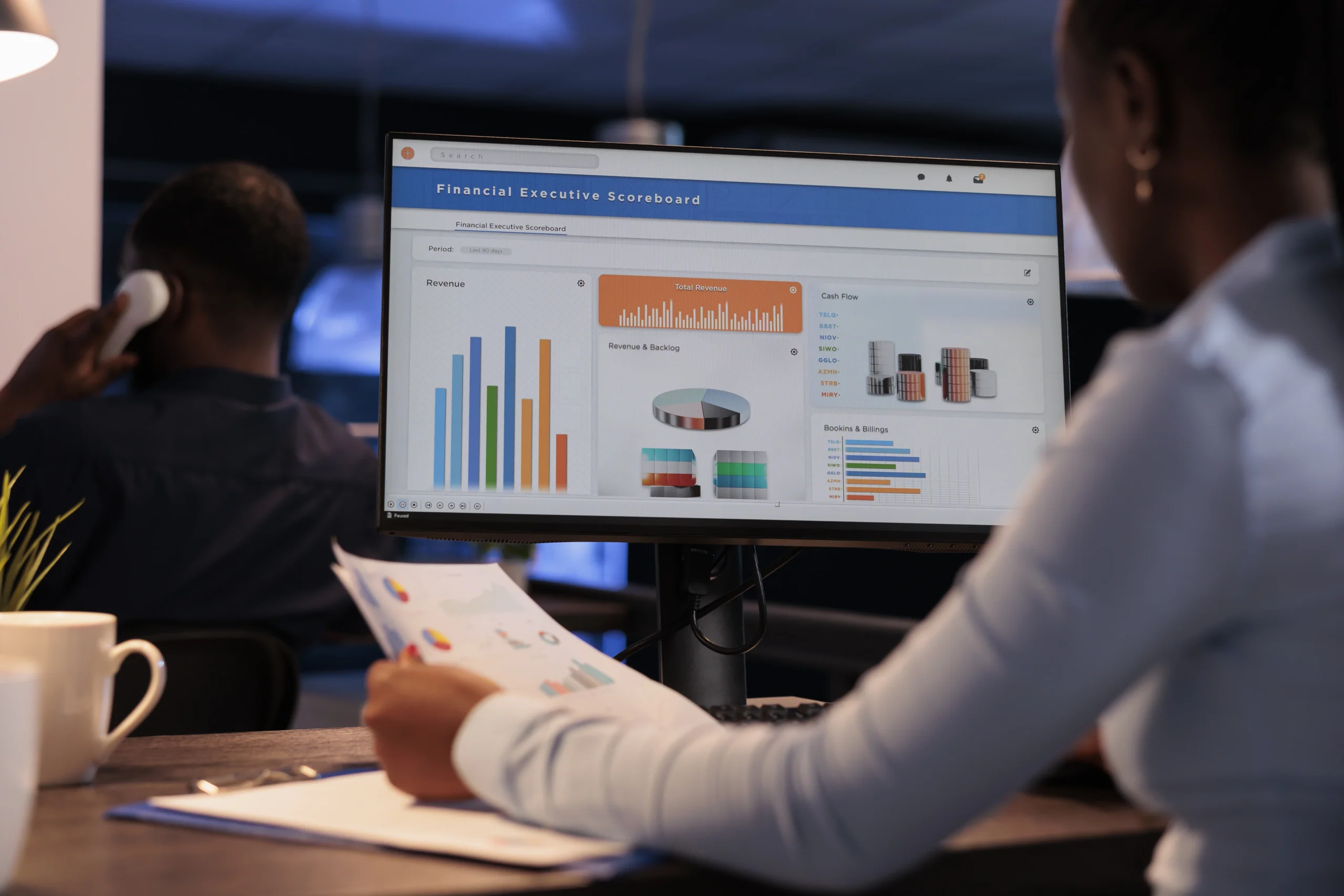 Office employee analyzing detailed business charts and graphs on a computer, demonstrating the power of custom reporting in decision-making.