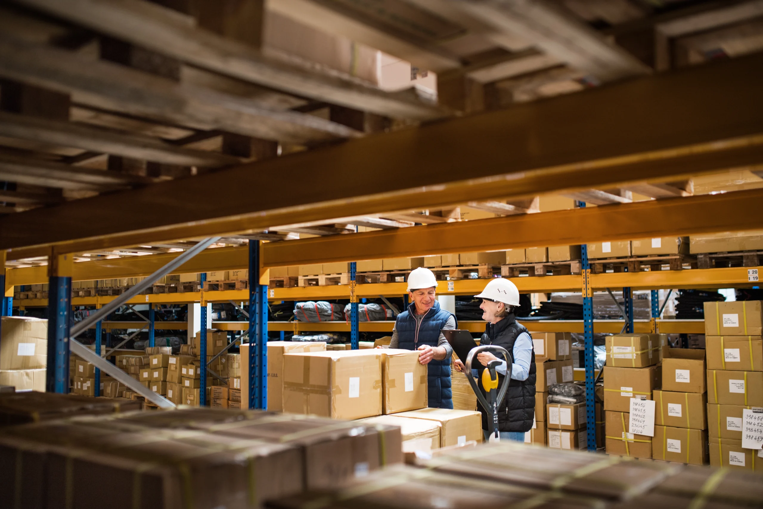 Senior warehouse supervisors inspecting inventory in a dedicated logistics facility.