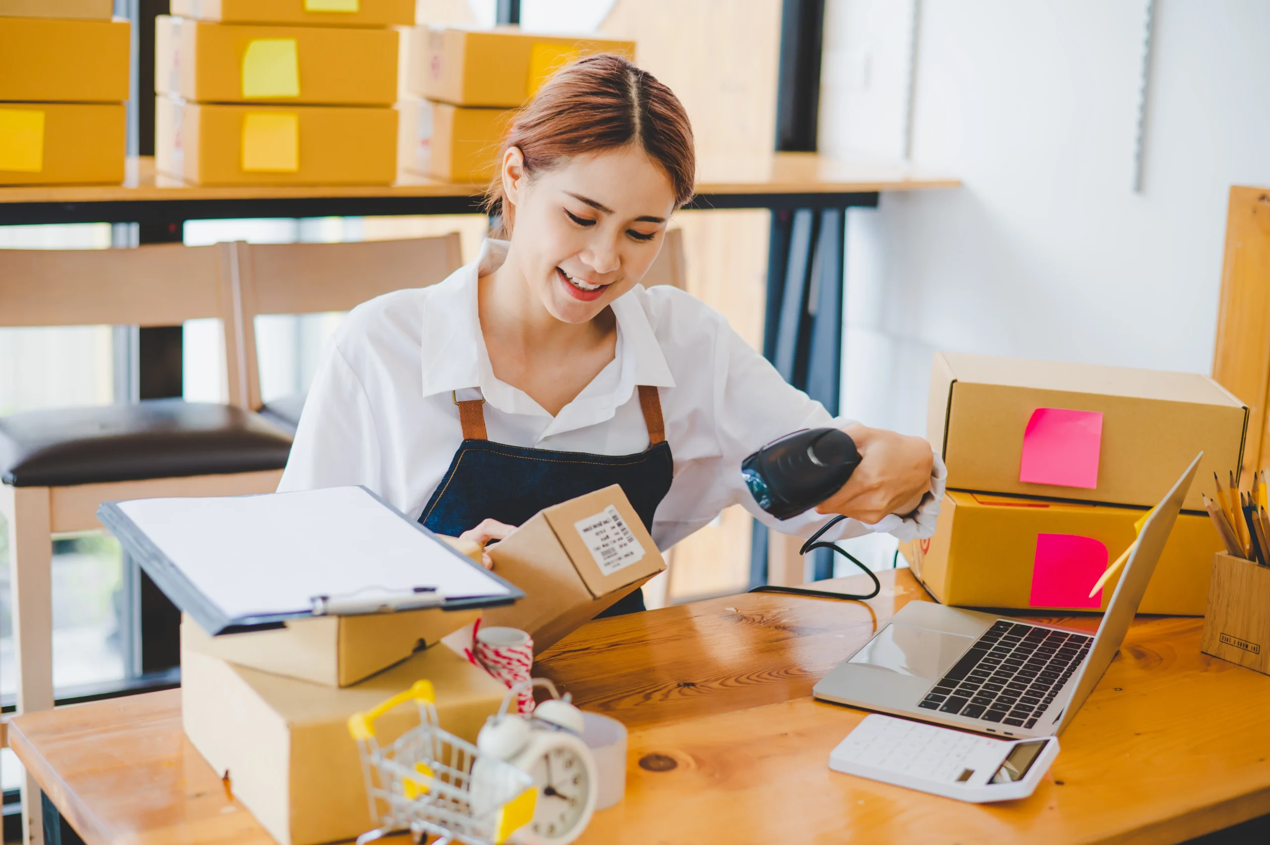 Entrepreneur scanning a barcode label on a package for order fulfillment.