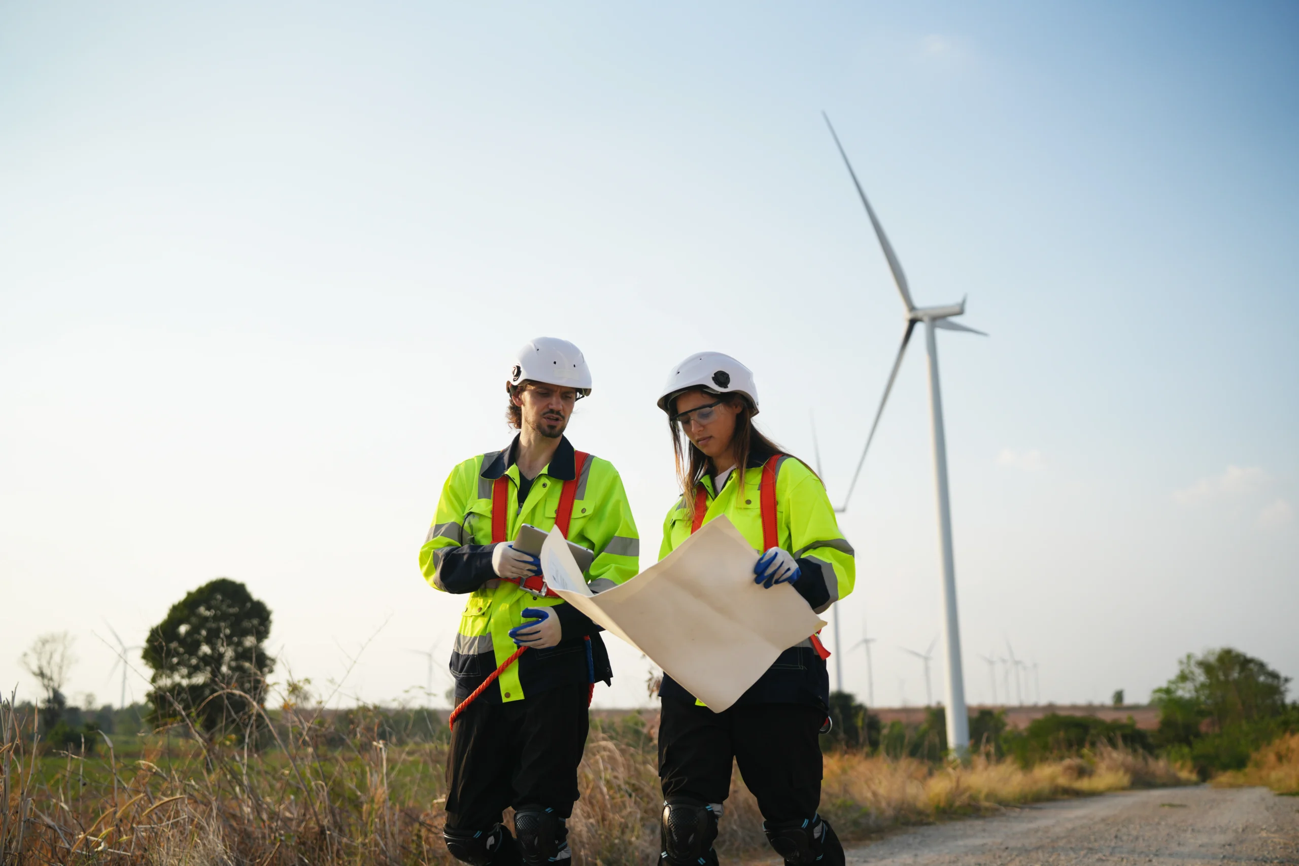 Two sustainable energy technicians discussing wind farm logistics at a rural site.Two sustainable energy technicians discussing wind farm logistics at a rural site.Two sustainable energy technicians discussing wind farm logistics at a rural site.Two sustainable energy technicians discussing wind farm logistics at a rural site.Two sustainable energy technicians discussing wind farm logistics at a rural site.Two sustainable energy technicians discussing wind farm logistics at a rural site.Two sustainable energy technicians discussing wind farm logistics at a rural site.Two sustainable energy technicians discussing wind farm logistics at a rural site.Two sustainable energy technicians discussing wind farm logistics at a rural site.Two sustainable energy technicians discussing wind farm logistics at a rural site.Two sustainable energy technicians discussing wind farm logistics at a rural site.Two sustainable energy technicians discussing wind farm logistics at a rural site.Two sustainable energy technicians discussing wind farm logistics at a rural site.Two sustainable energy technicians discussing wind farm logistics at a rural site.Two sustainable energy technicians discussing wind farm logistics at a rural site.Two sustainable energy technicians discussing wind farm logistics at a rural site.