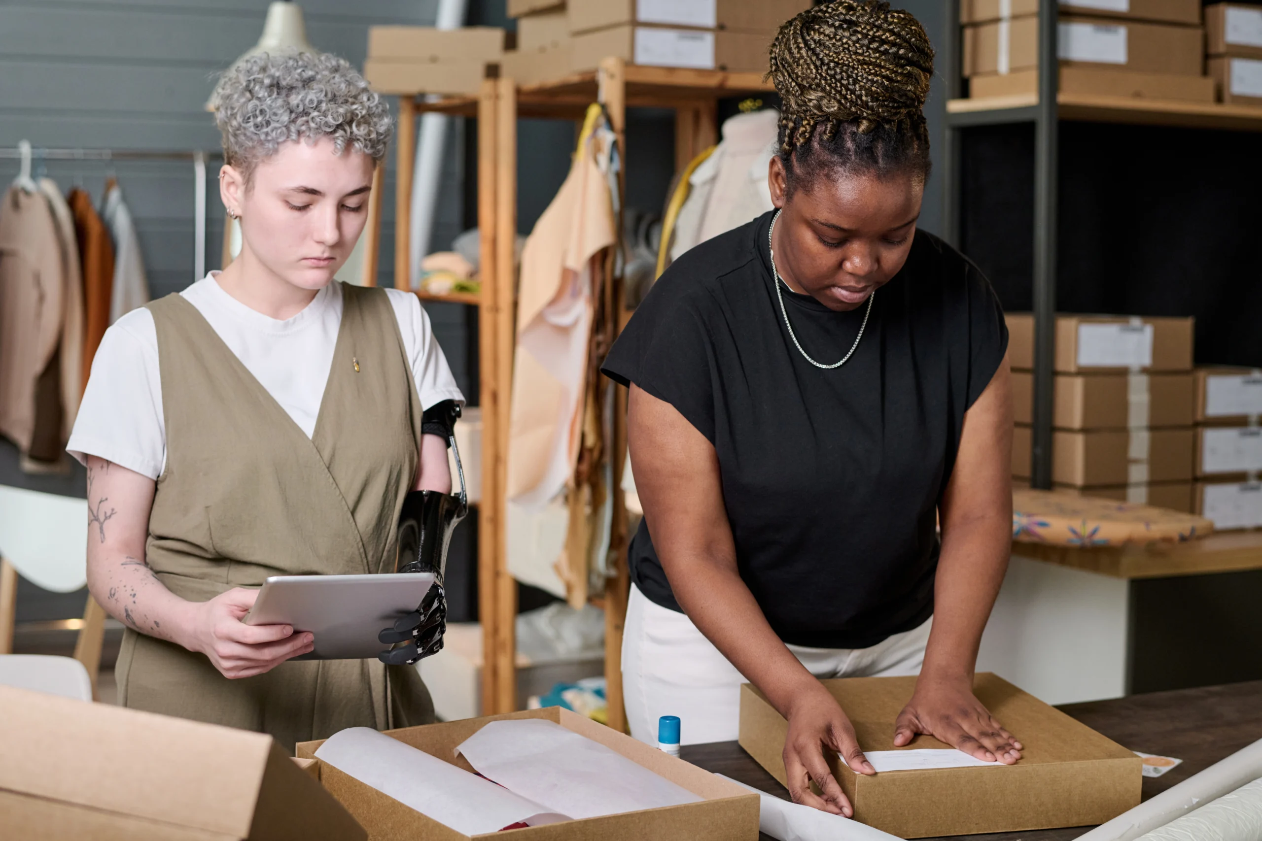 A professional team utilizing modern tools and technology in a warehouse setting to track and manage inventory efficiently. The image represents effective inventory management services focused on improving operations, reducing costs, and ensuring accuracy.