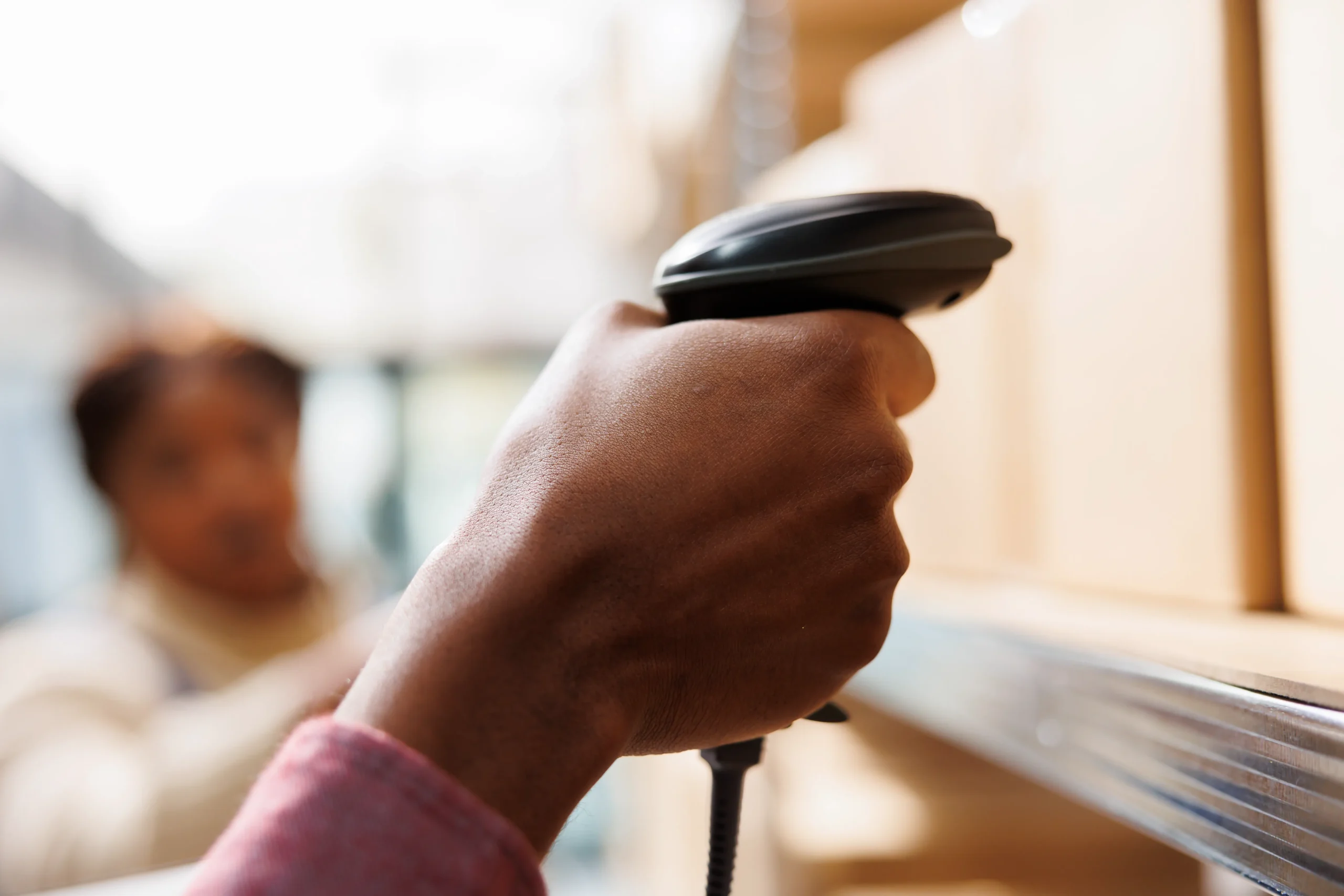 A warehouse worker scanning a barcode label on a package, demonstrating the efficiency of linear barcode types in logistics.