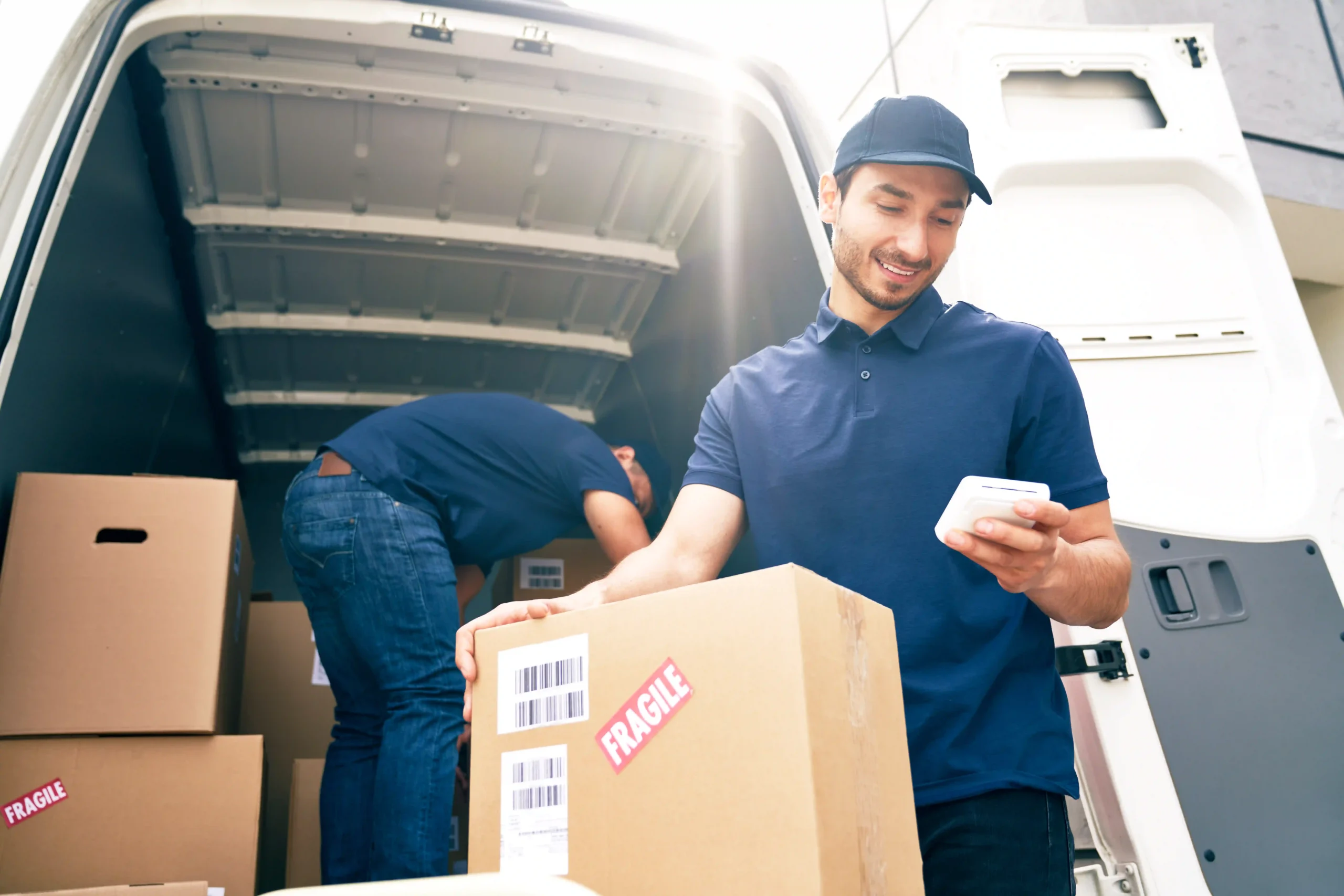 Logistics team unloading packages from a van, demonstrating an effective pick and ship service.