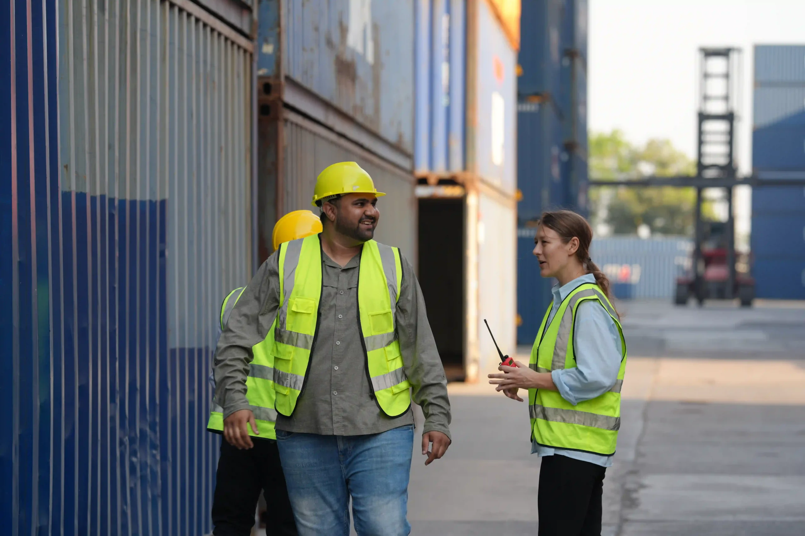 A Foreign Trade Zone (FTZ) Coordinator overseeing cargo container loading at a busy shipping yard, ensuring compliance and efficient supply chain management.