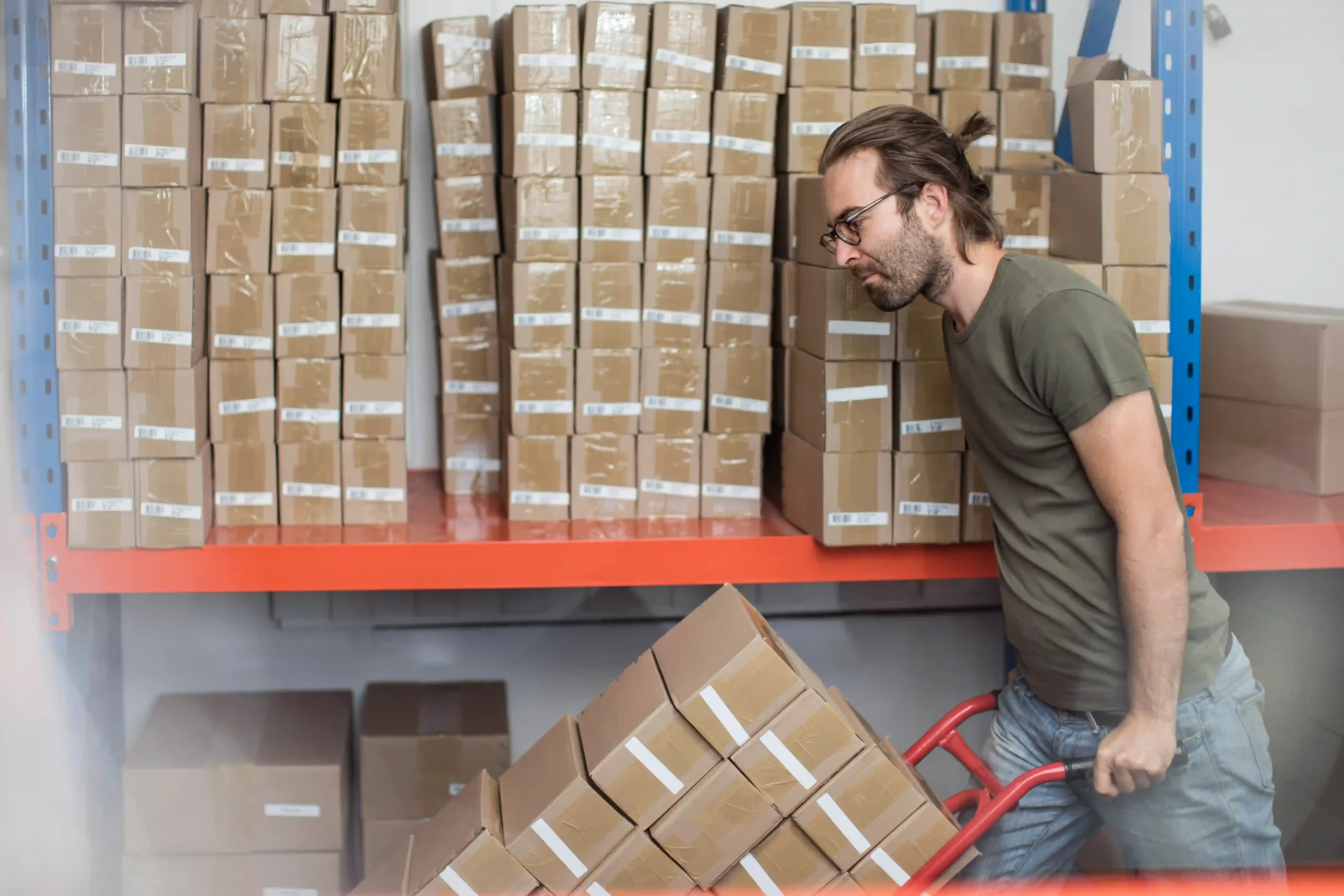 Warehouse staff moving inventory as part of a pick and ship service to streamline fulfillment.