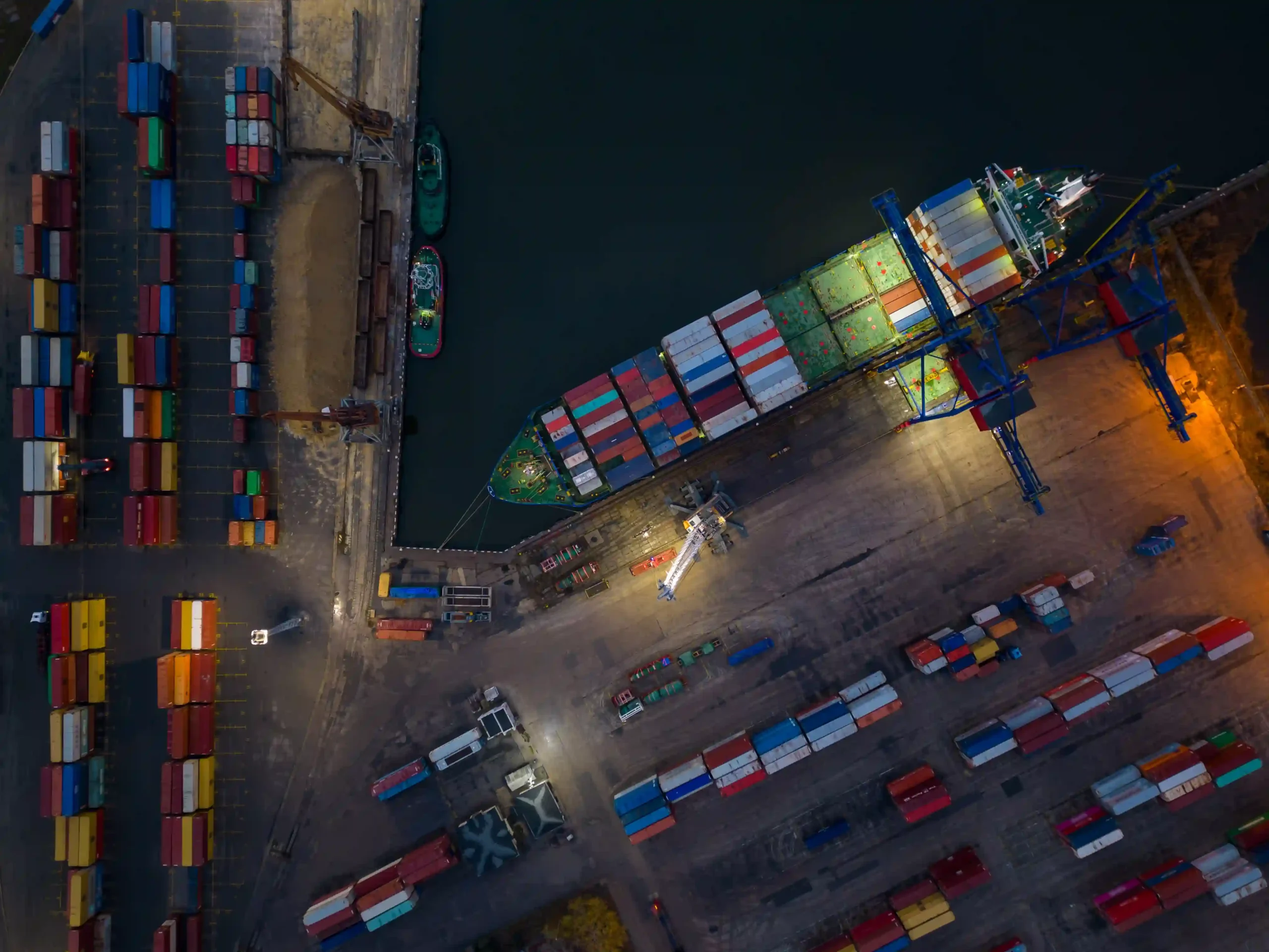 A cargo ship docked at a busy international port, showcasing global trade logistics and strategies for dodging high tariffs.