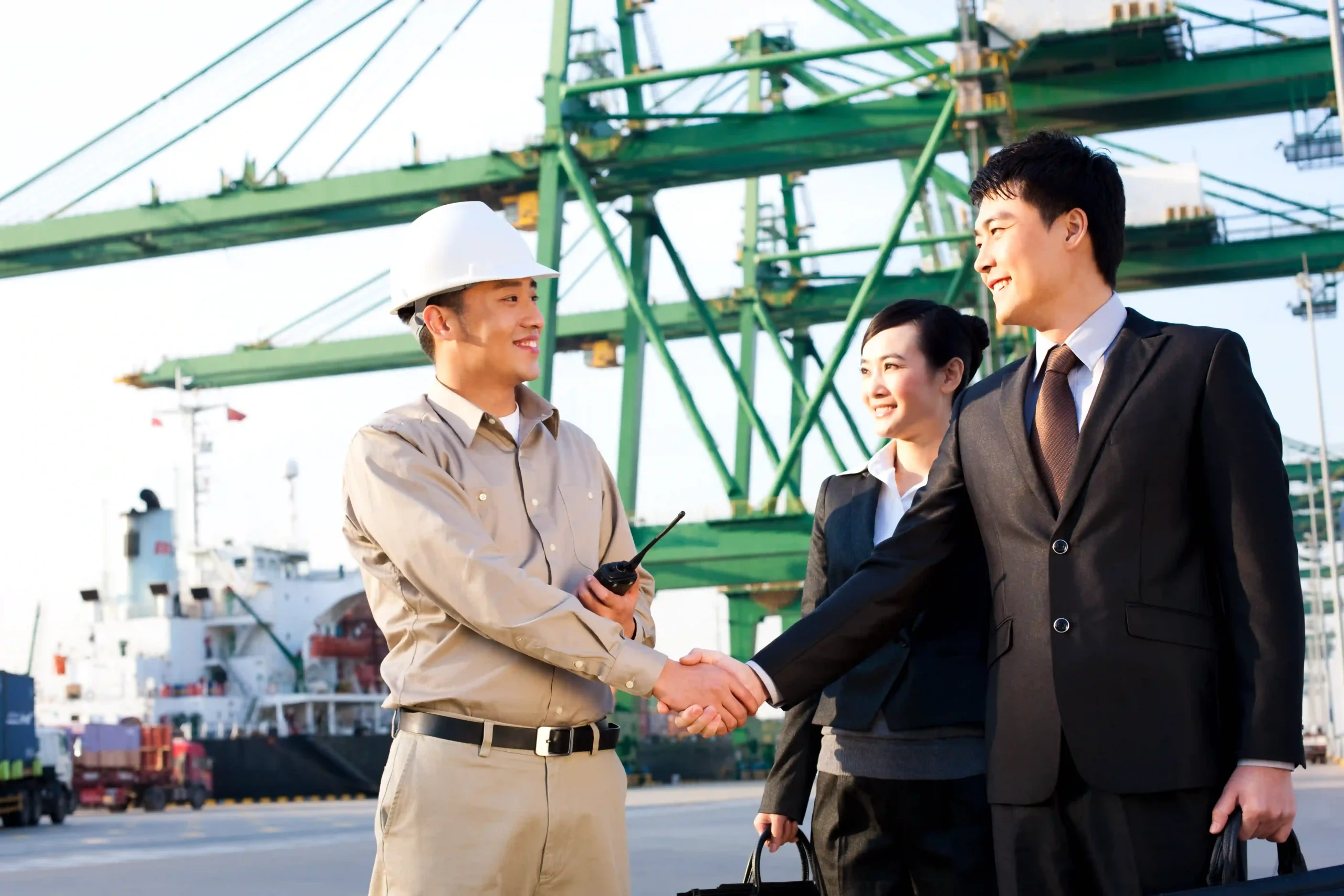 A logistics expert and business leaders finalizing FTZ compliance requirements 2025 at a shipping port.