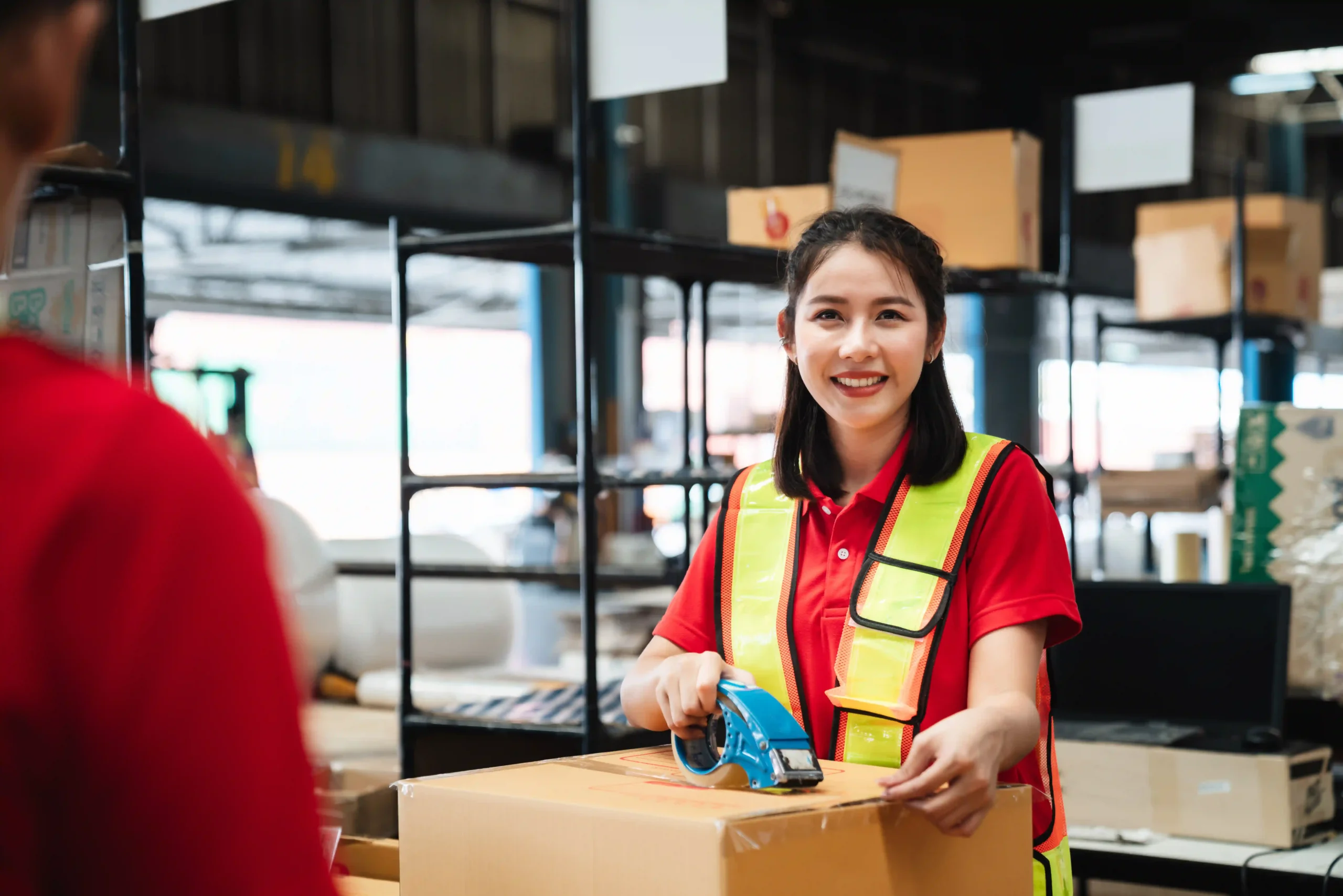 A logistics worker scanning inventory data to enhance real-time supply chain optimization and reduce errors in stock management.