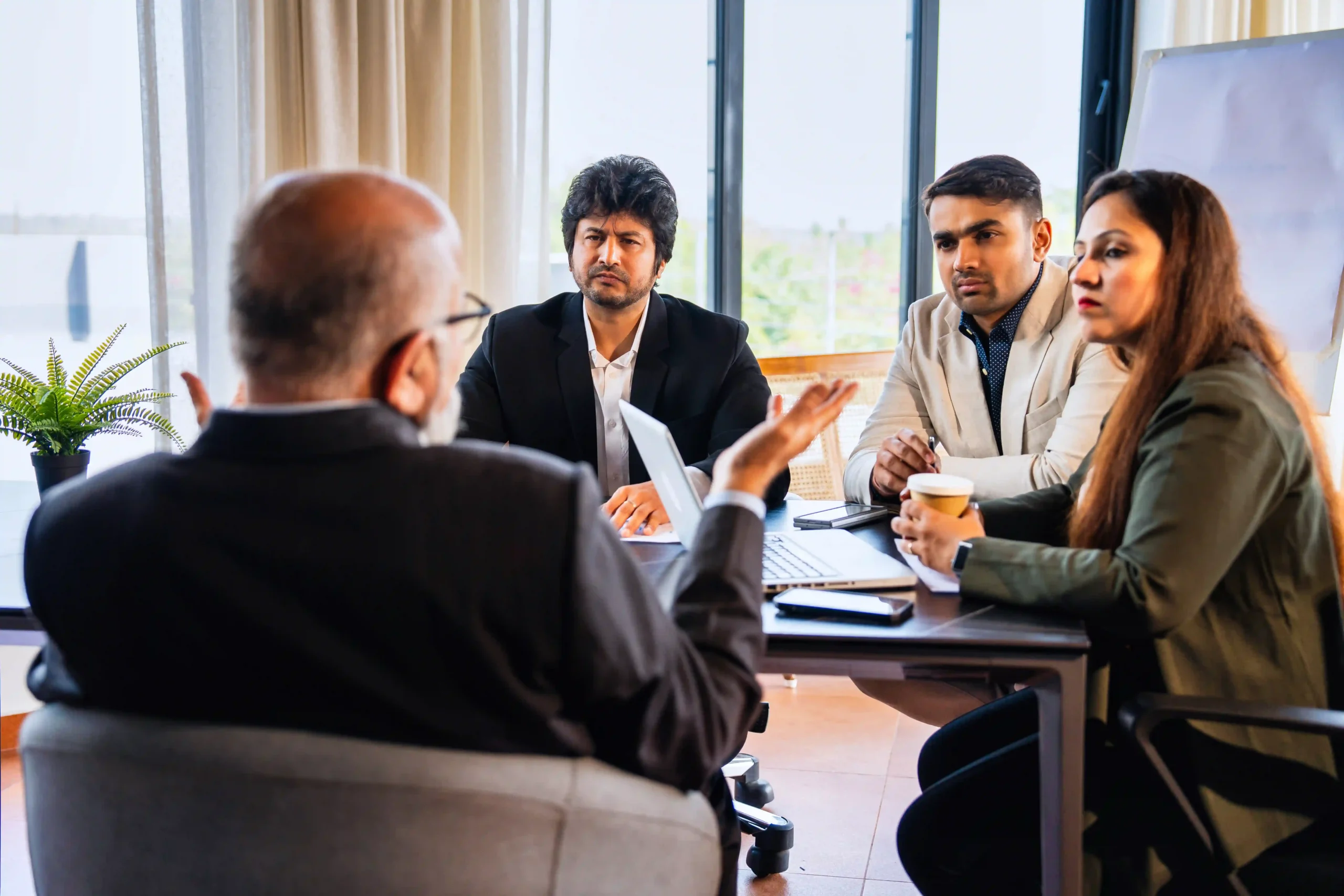 Business leaders strategizing around updates to trade compliance regulations 2025 during a logistics planning meeting.