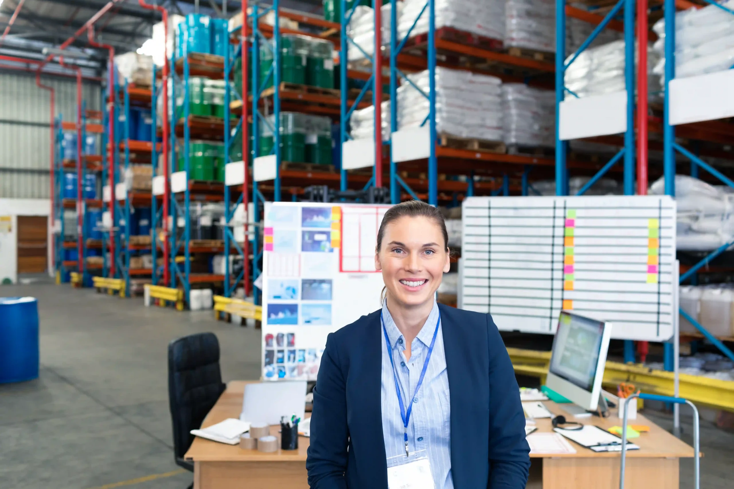 FTZ administrator standing in a warehouse office with logistics charts