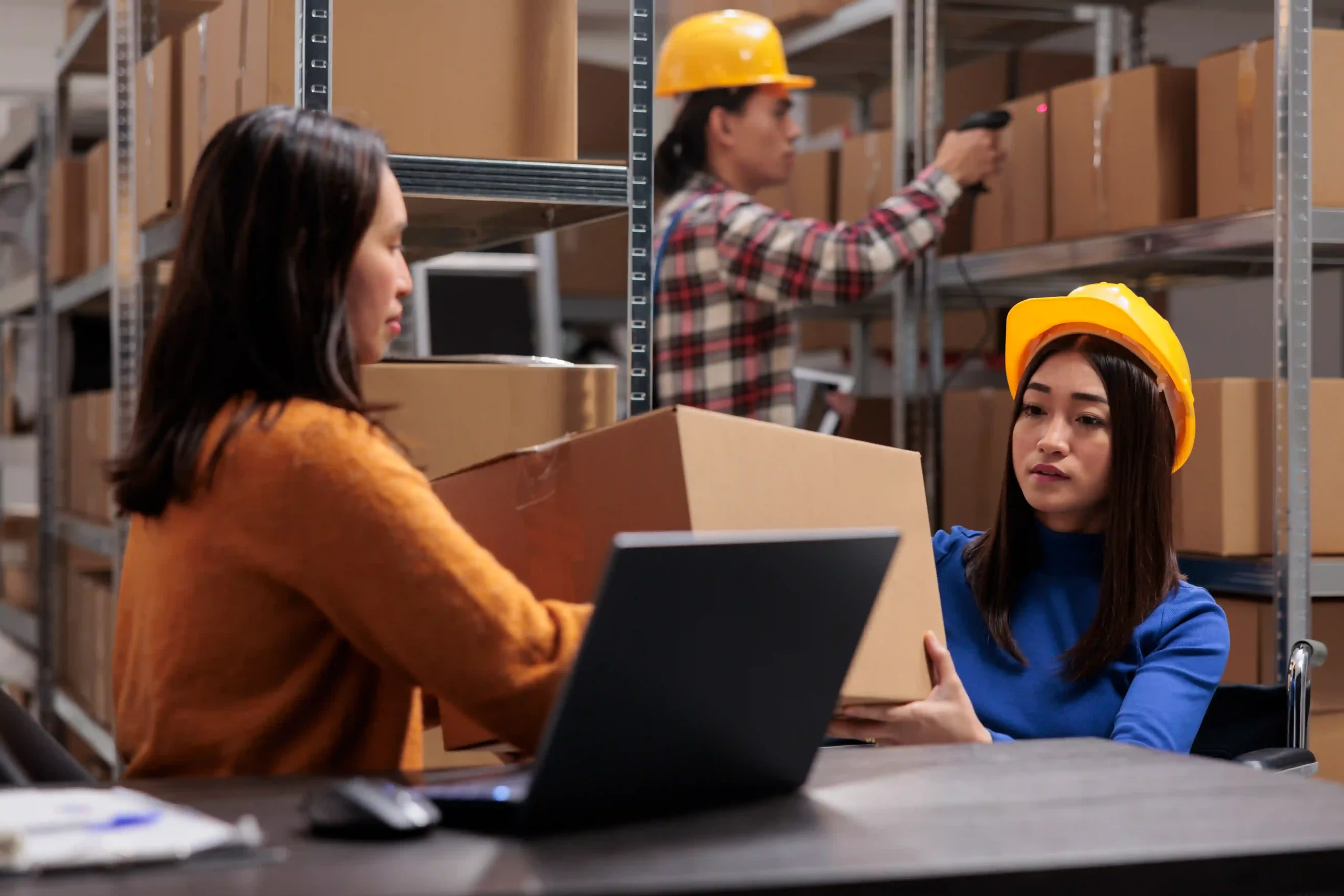 Warehouse staff inspecting packages in an order management example