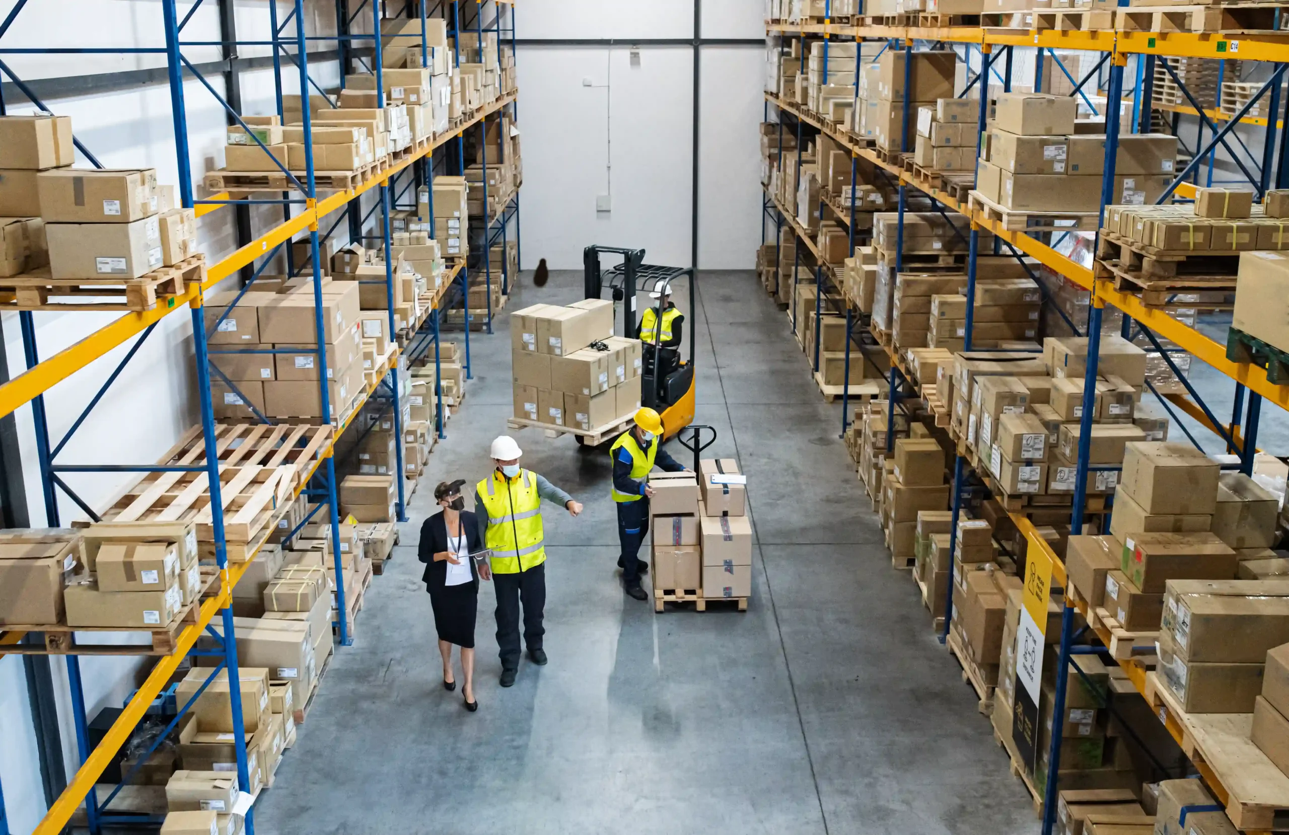Team of warehouse workers and a manager coordinating freight in a cross docking distribution center