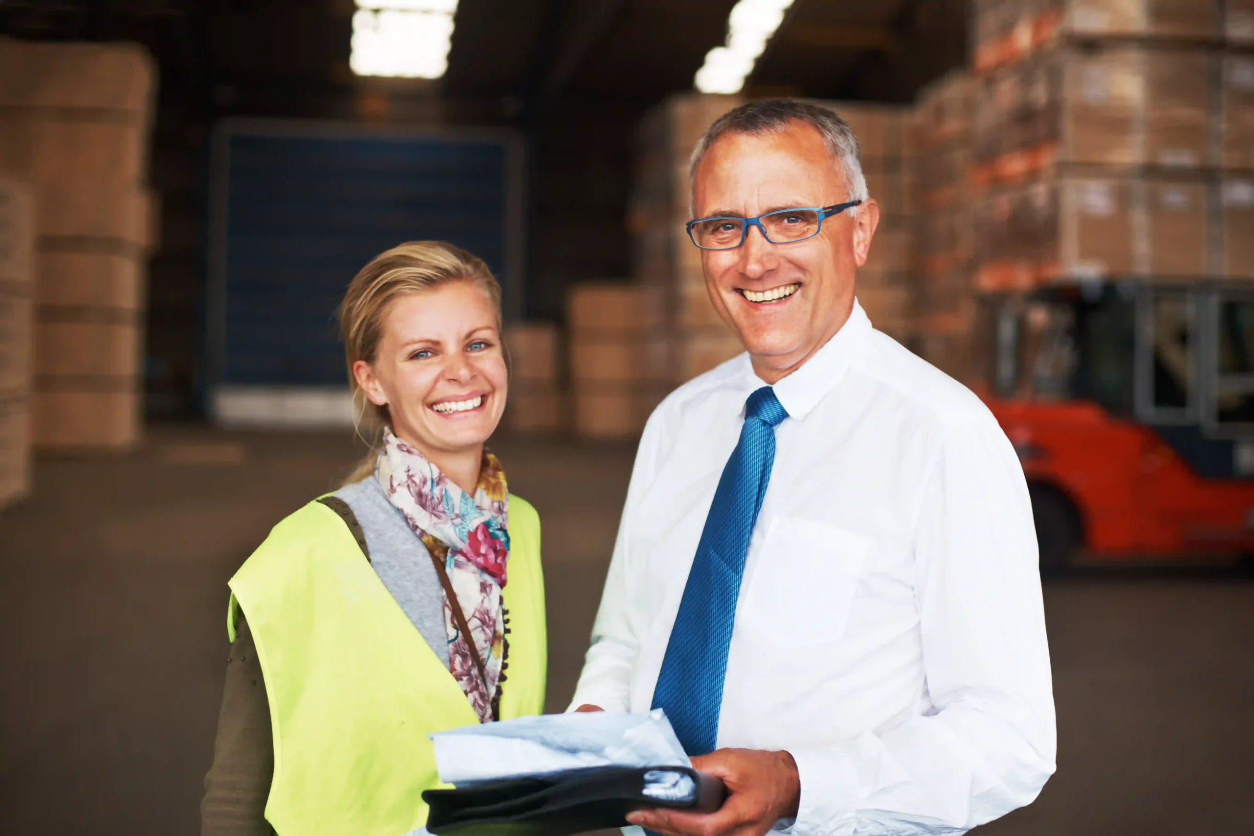 FTZ administrator and team member smiling inside an organized storage facility