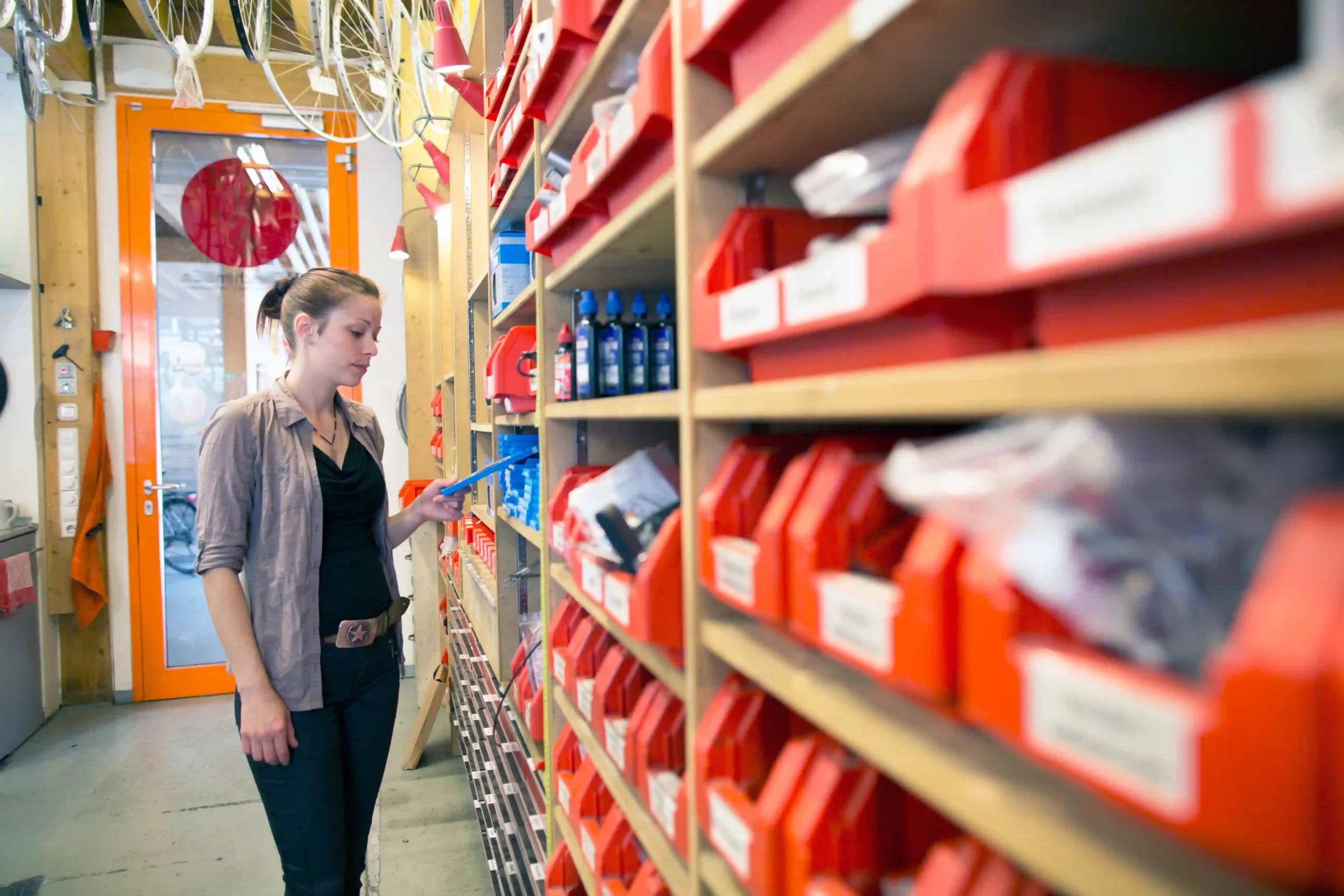 Inventory management explained in a small business setting with labeled parts and organized shelves